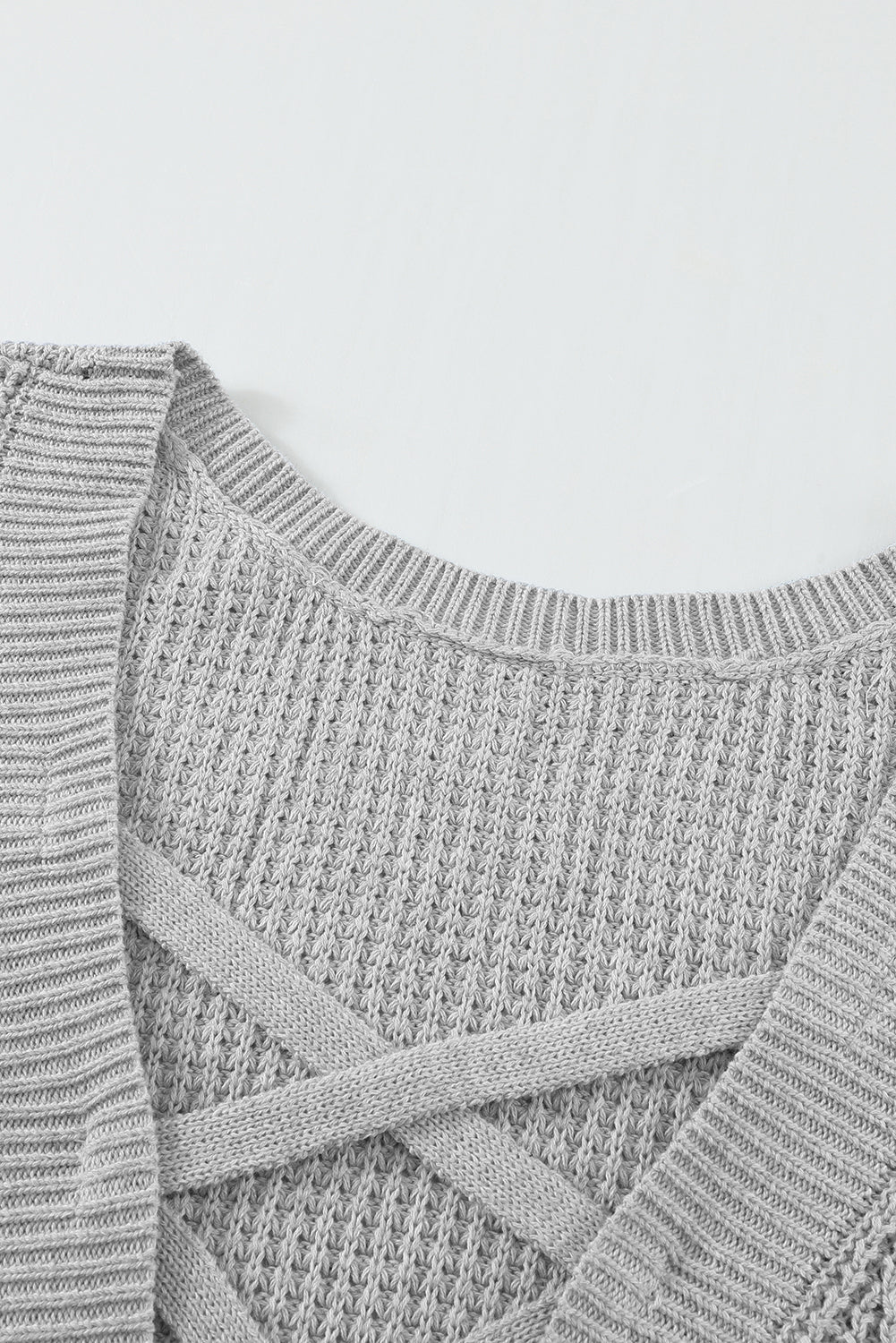 Gray Cross Back Hollow-out Sweater featuring a deep V hollow-out design and crisscross back, perfect for stylish layering.