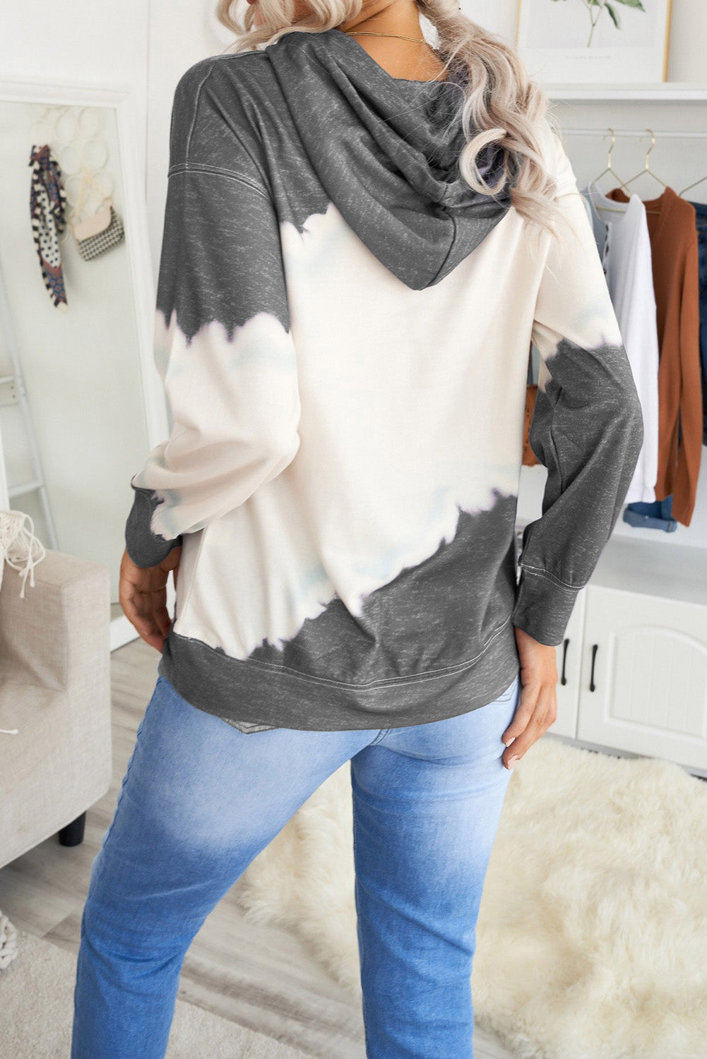 Gray hooded sweatshirt featuring a stylish tie-dye print and a functional front pocket, perfect for casual wear.