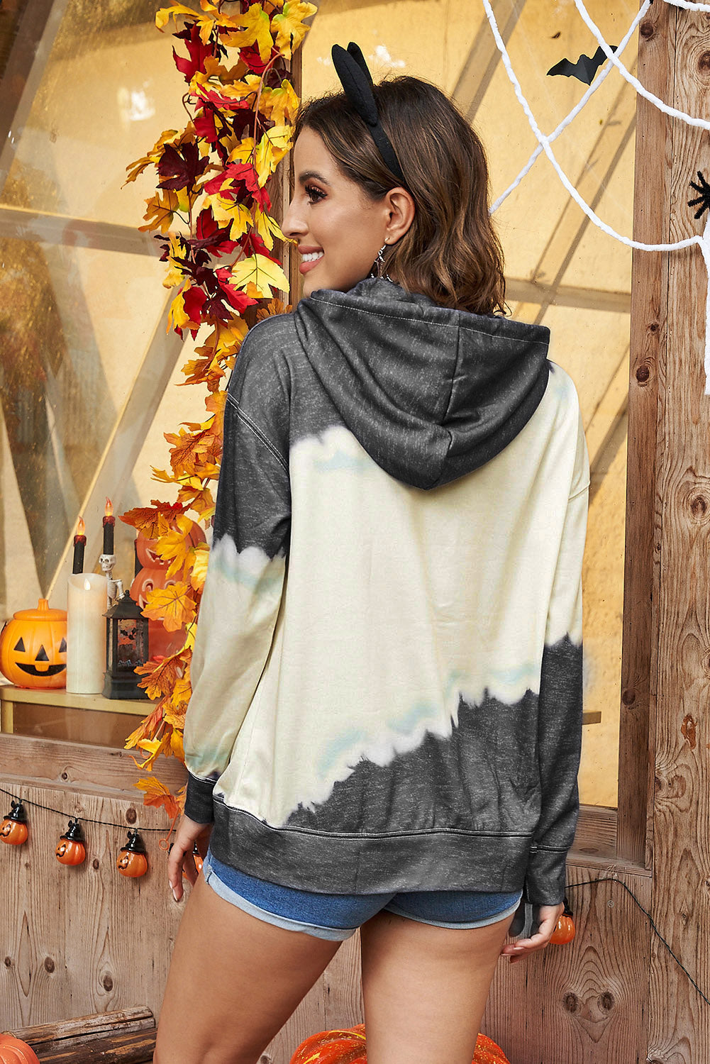 Gray hooded sweatshirt featuring a stylish tie-dye print and a functional front pocket, perfect for casual wear.