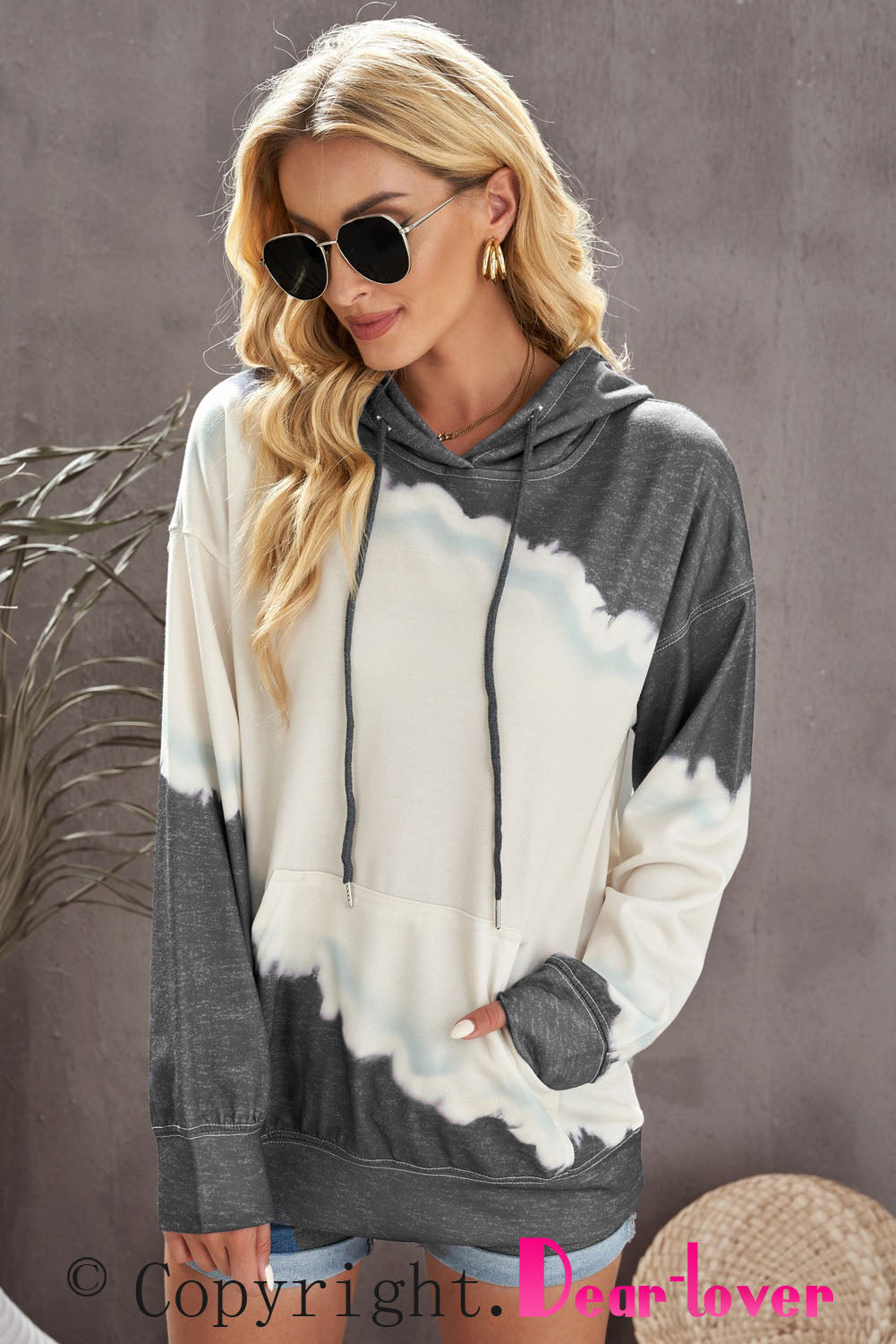 Gray hooded sweatshirt featuring a stylish tie-dye print and a functional front pocket, perfect for casual wear.