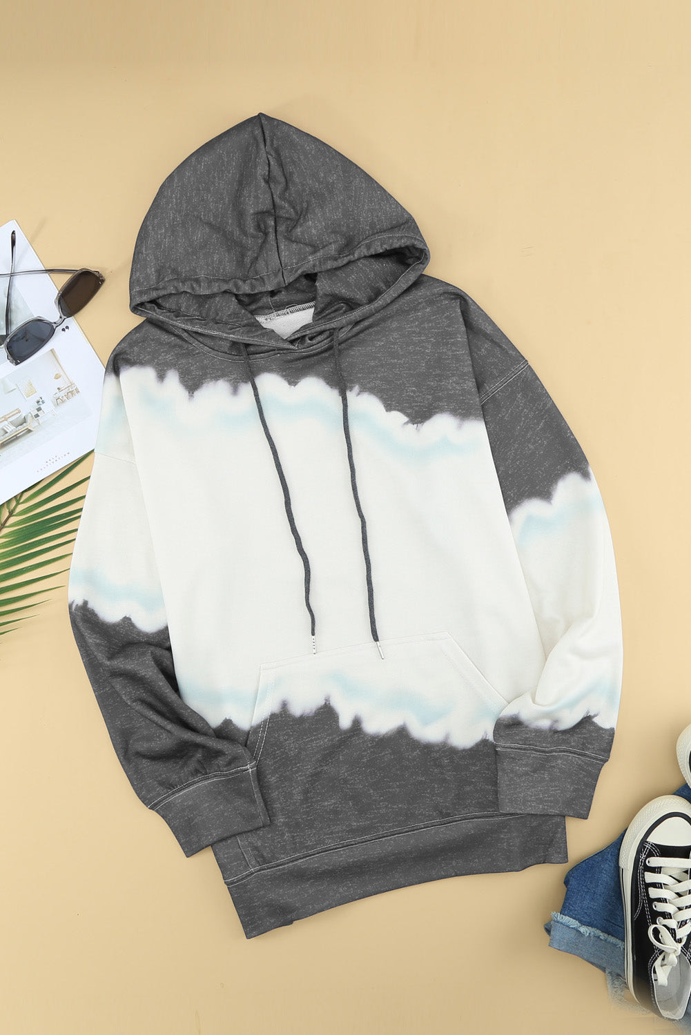 Gray hooded sweatshirt featuring a stylish tie-dye print and a functional front pocket, perfect for casual wear.