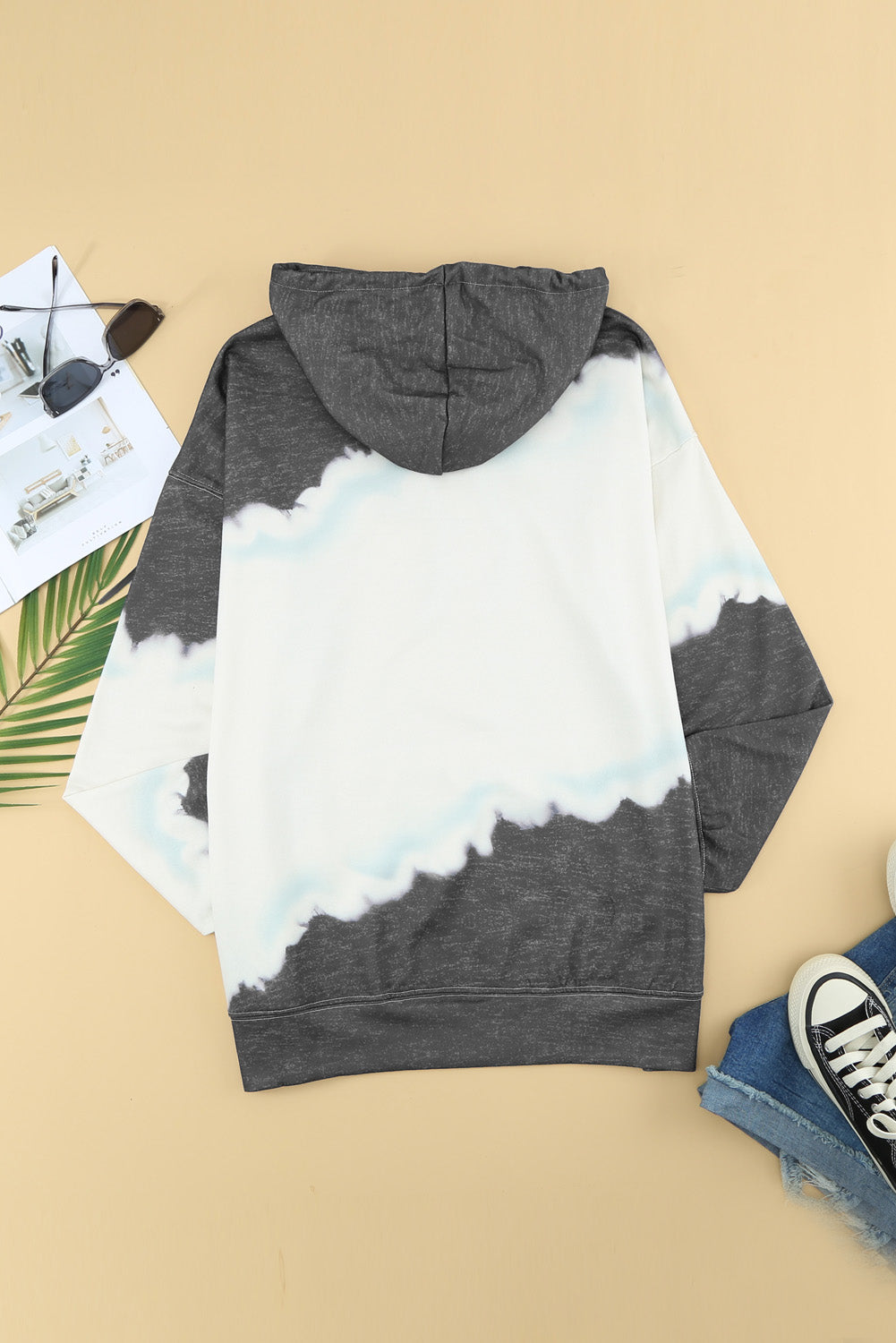 Gray hooded sweatshirt featuring a stylish tie-dye print and a functional front pocket, perfect for casual wear.