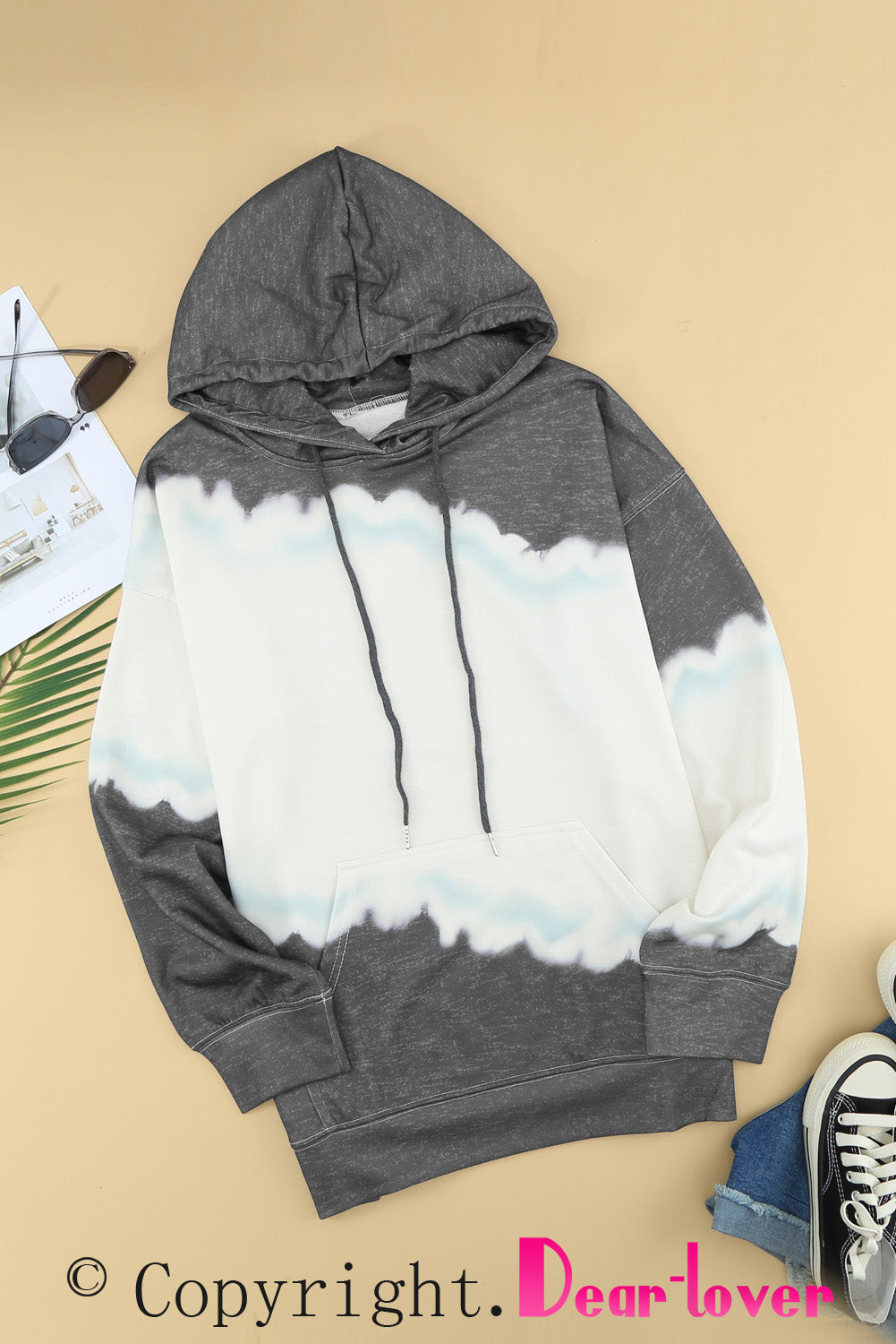 Gray hooded sweatshirt featuring a stylish tie-dye print and a functional front pocket, perfect for casual wear.