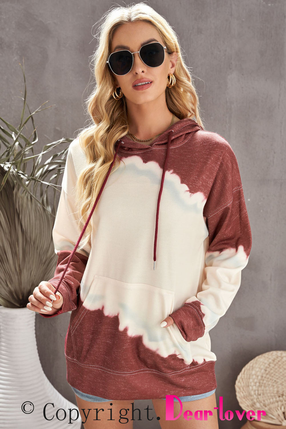 Gray hooded sweatshirt featuring a stylish tie-dye print and a functional front pocket, perfect for casual wear.