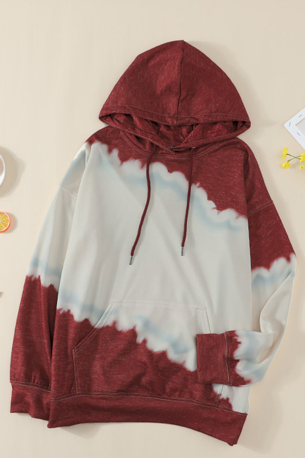 Gray hooded sweatshirt featuring a stylish tie-dye print and a functional front pocket, perfect for casual wear.