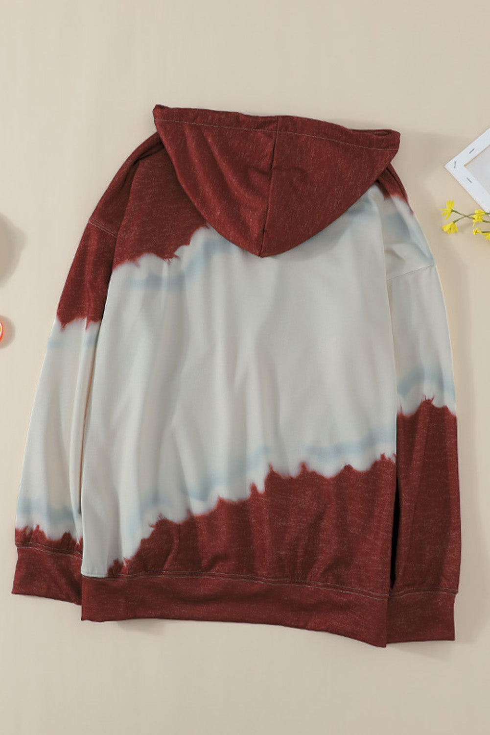 Gray hooded sweatshirt featuring a stylish tie-dye print and a functional front pocket, perfect for casual wear.