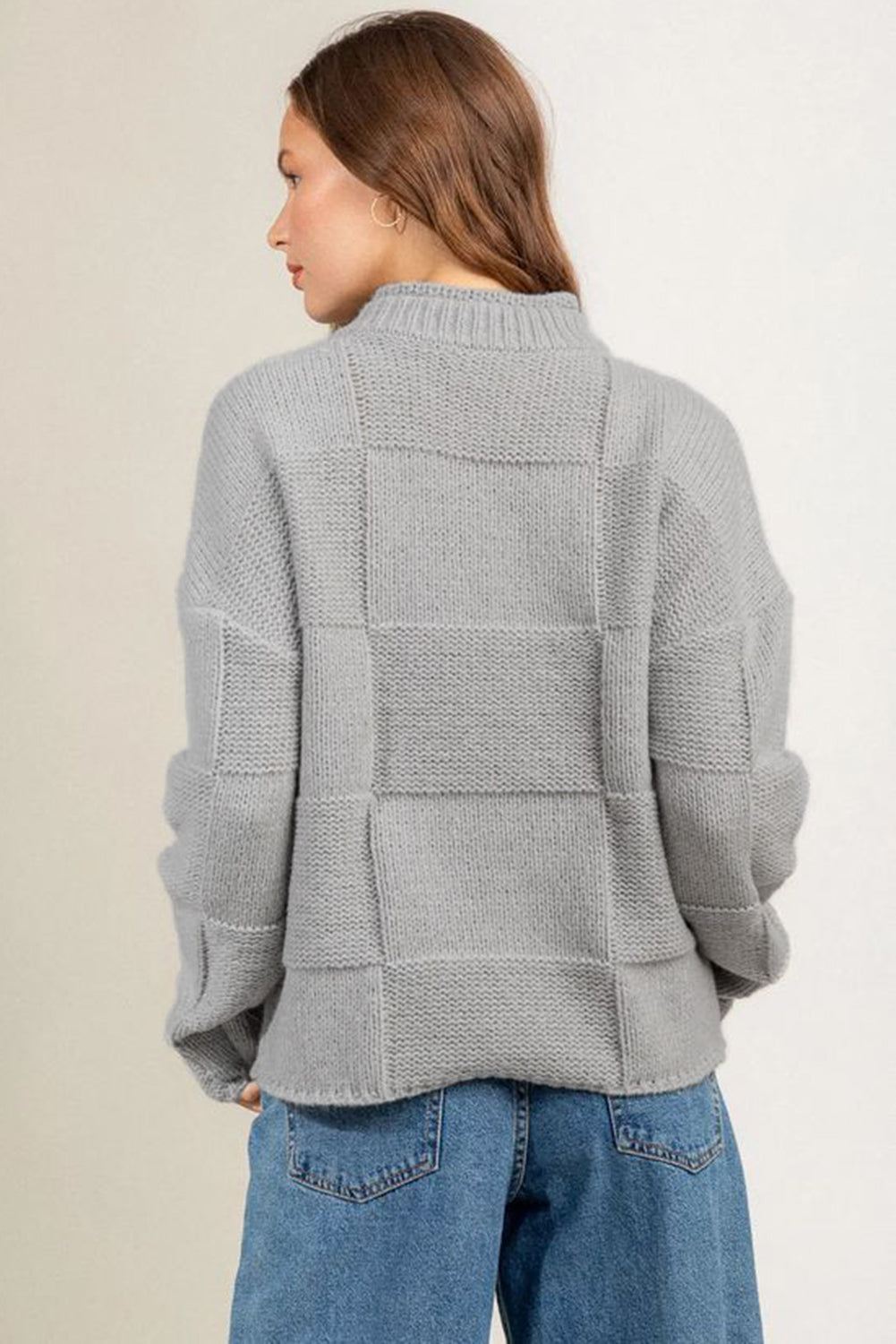 Gray mock neck checkered textured sweater displayed on a mannequin, showcasing its stylish design and soft fabric.