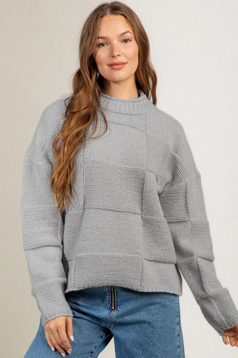 Gray mock neck checkered textured sweater displayed on a mannequin, showcasing its stylish design and soft fabric.