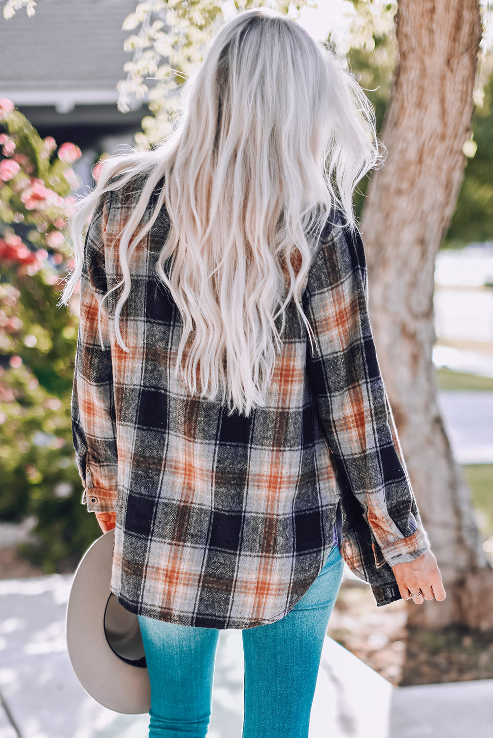 Gray oversize plaid shacket with rounded hem and slits, showcasing a stylish and comfortable design suitable for various outfits.