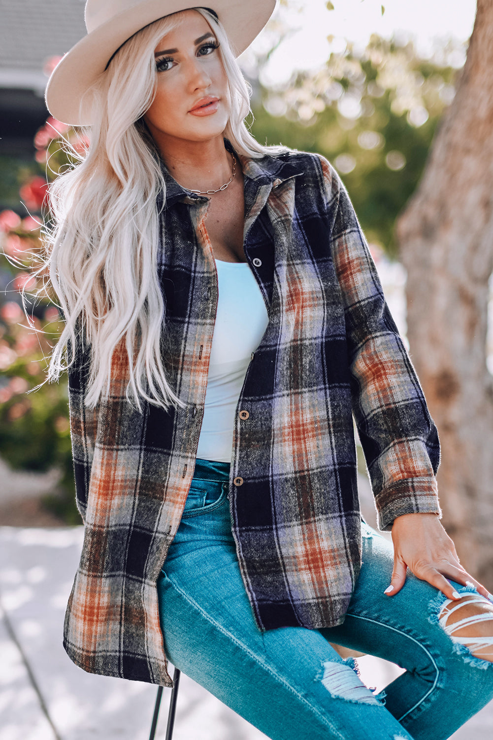 Gray oversize plaid shacket with rounded hem and slits, showcasing a stylish and comfortable design suitable for various outfits.