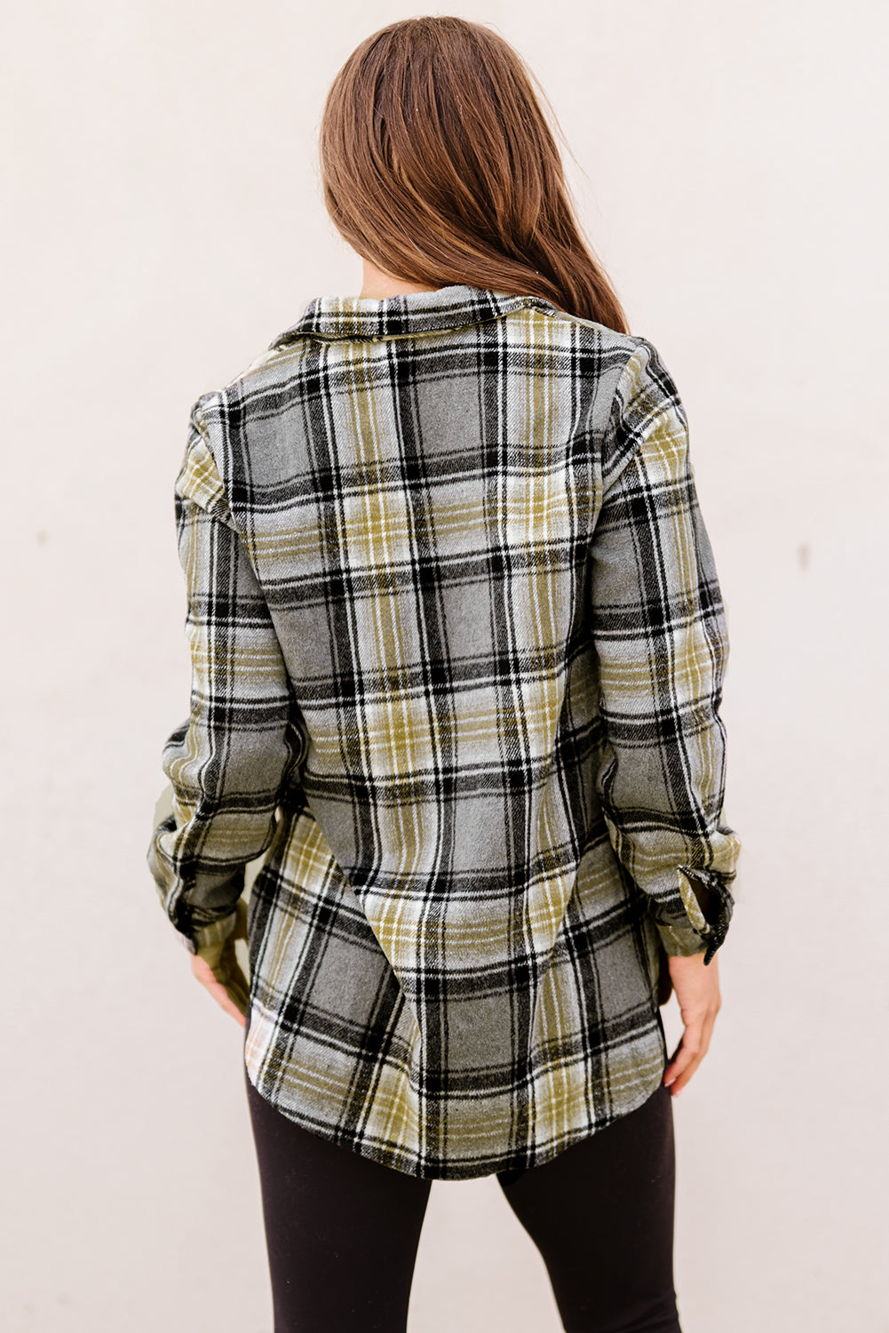 Gray oversize plaid shacket with rounded hem and slits, showcasing a stylish and comfortable design suitable for various outfits.