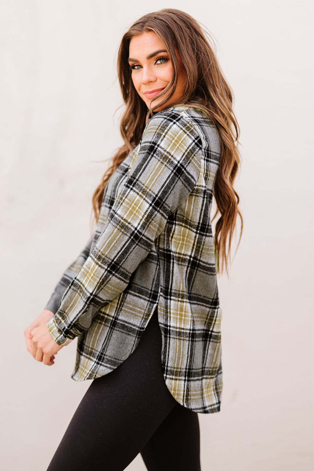 Gray oversize plaid shacket with rounded hem and slits, showcasing a stylish and comfortable design suitable for various outfits.