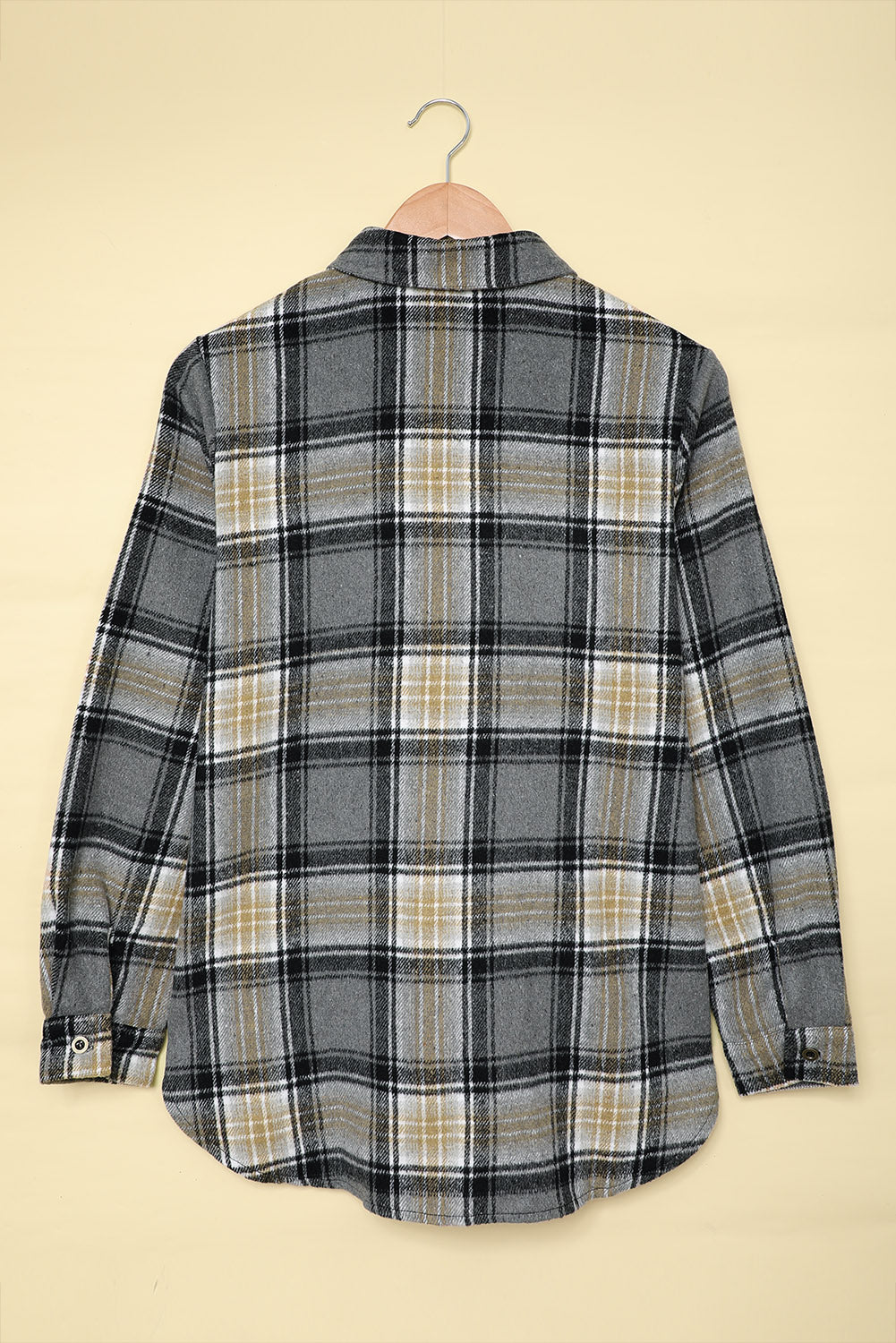 Gray oversize plaid shacket with rounded hem and slits, showcasing a stylish and comfortable design suitable for various outfits.