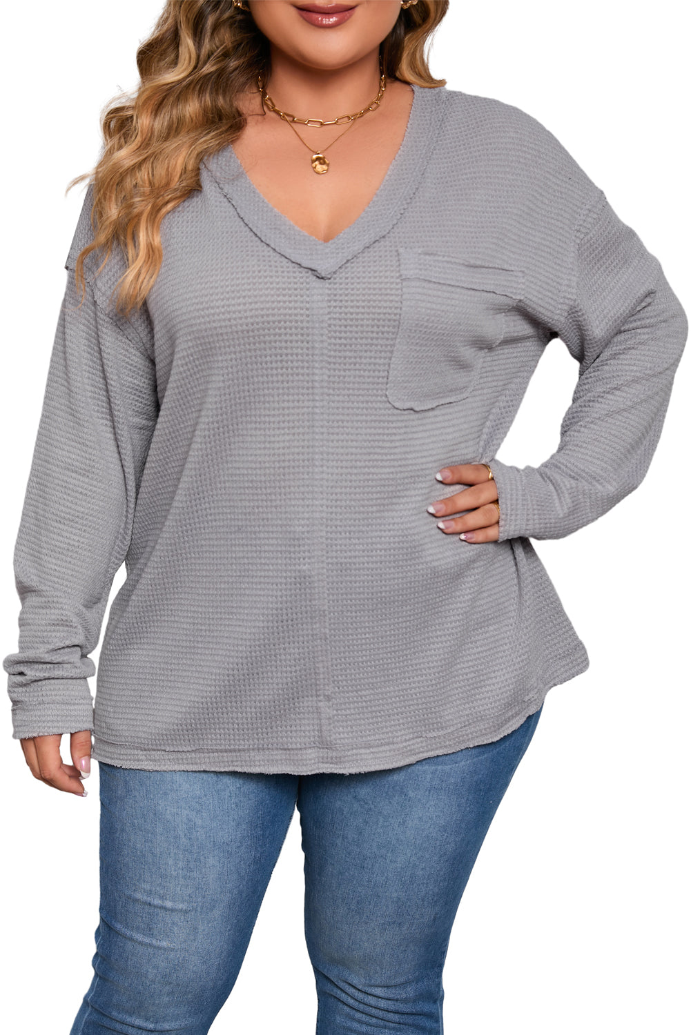 Gray Plus Size V Neck Raw Edge Long Sleeve Top displayed on a mannequin, showcasing its relaxed fit and trendy design.