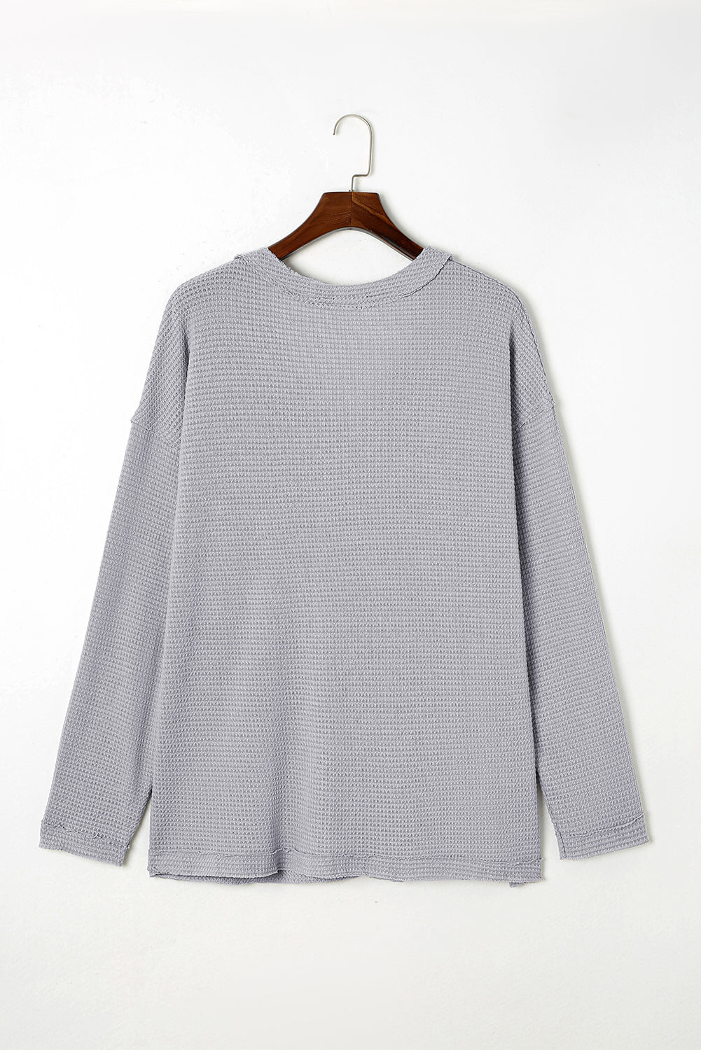 Gray Plus Size V Neck Raw Edge Long Sleeve Top displayed on a mannequin, showcasing its relaxed fit and trendy design.