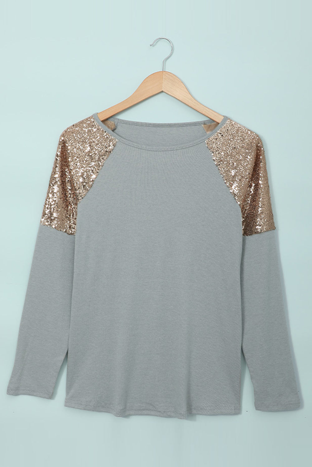 Gray long sleeve top with sequin shoulder detailing, showcasing a classic round neck and soft knit fabric.