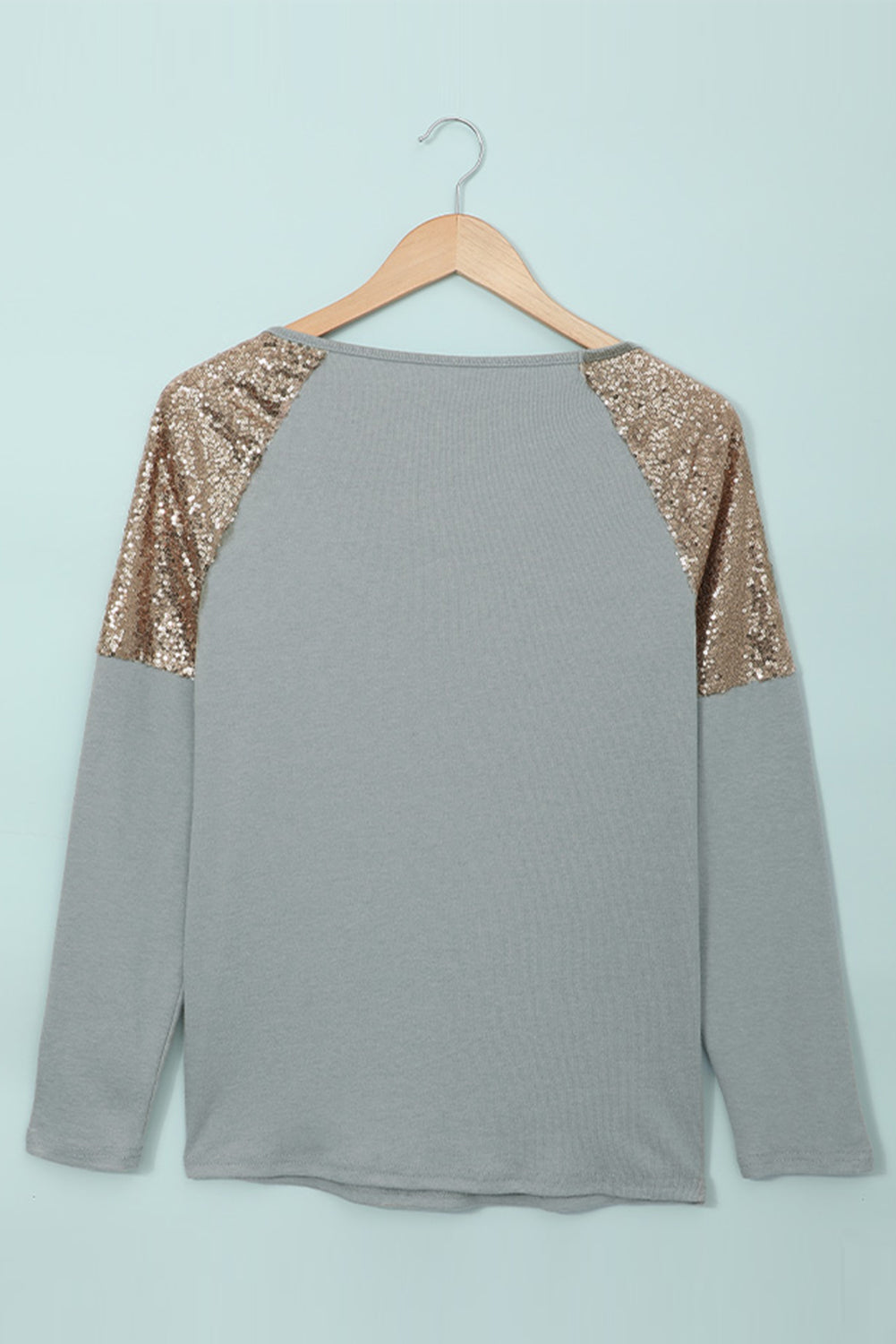 Gray long sleeve top with sequin shoulder detailing, showcasing a classic round neck and soft knit fabric.