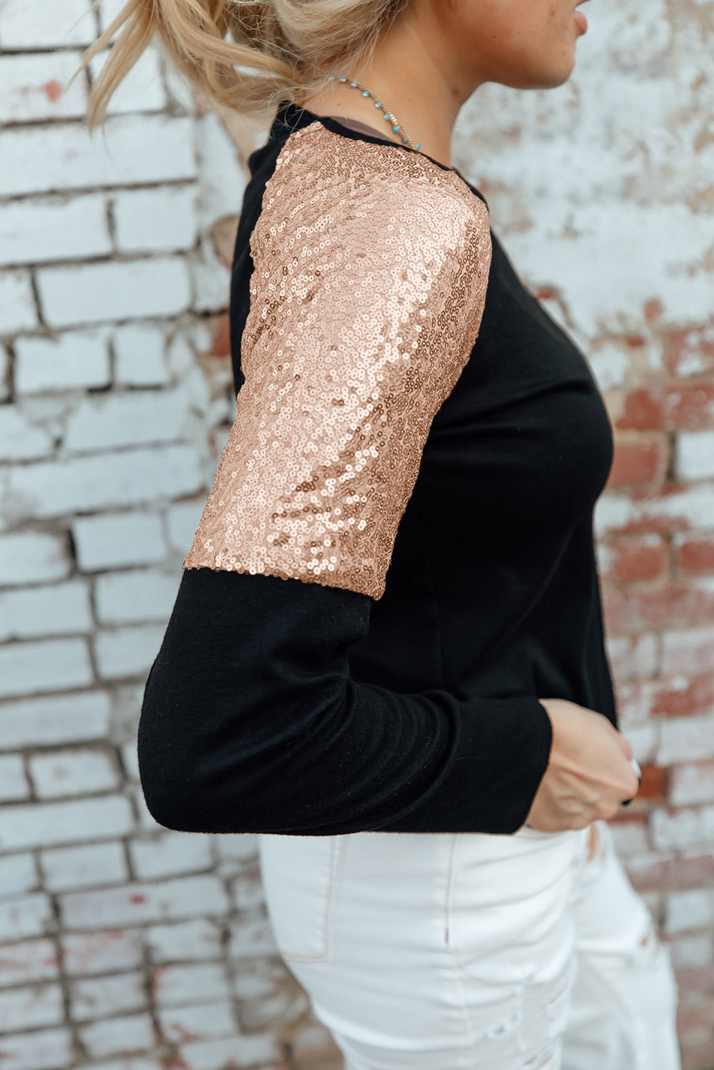 Gray long sleeve top with sequin shoulder detailing, showcasing a classic round neck and soft knit fabric.