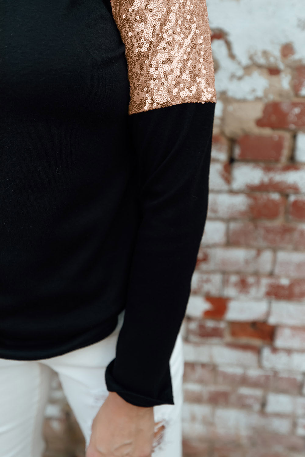 Gray long sleeve top with sequin shoulder detailing, showcasing a classic round neck and soft knit fabric.