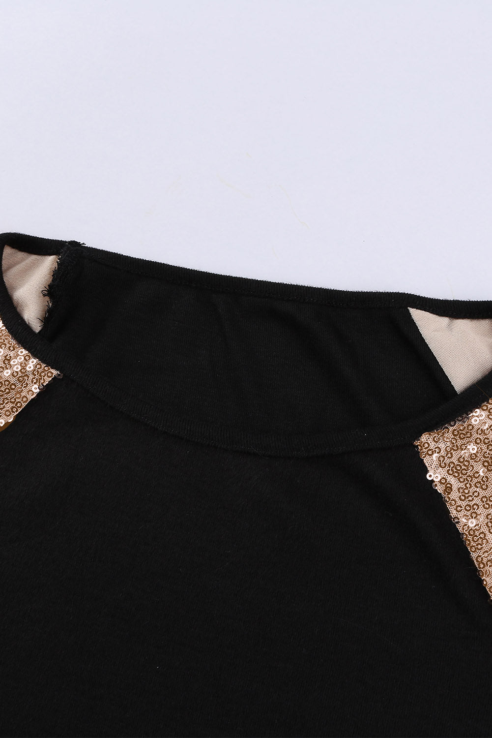 Gray long sleeve top with sequin shoulder detailing, showcasing a classic round neck and soft knit fabric.