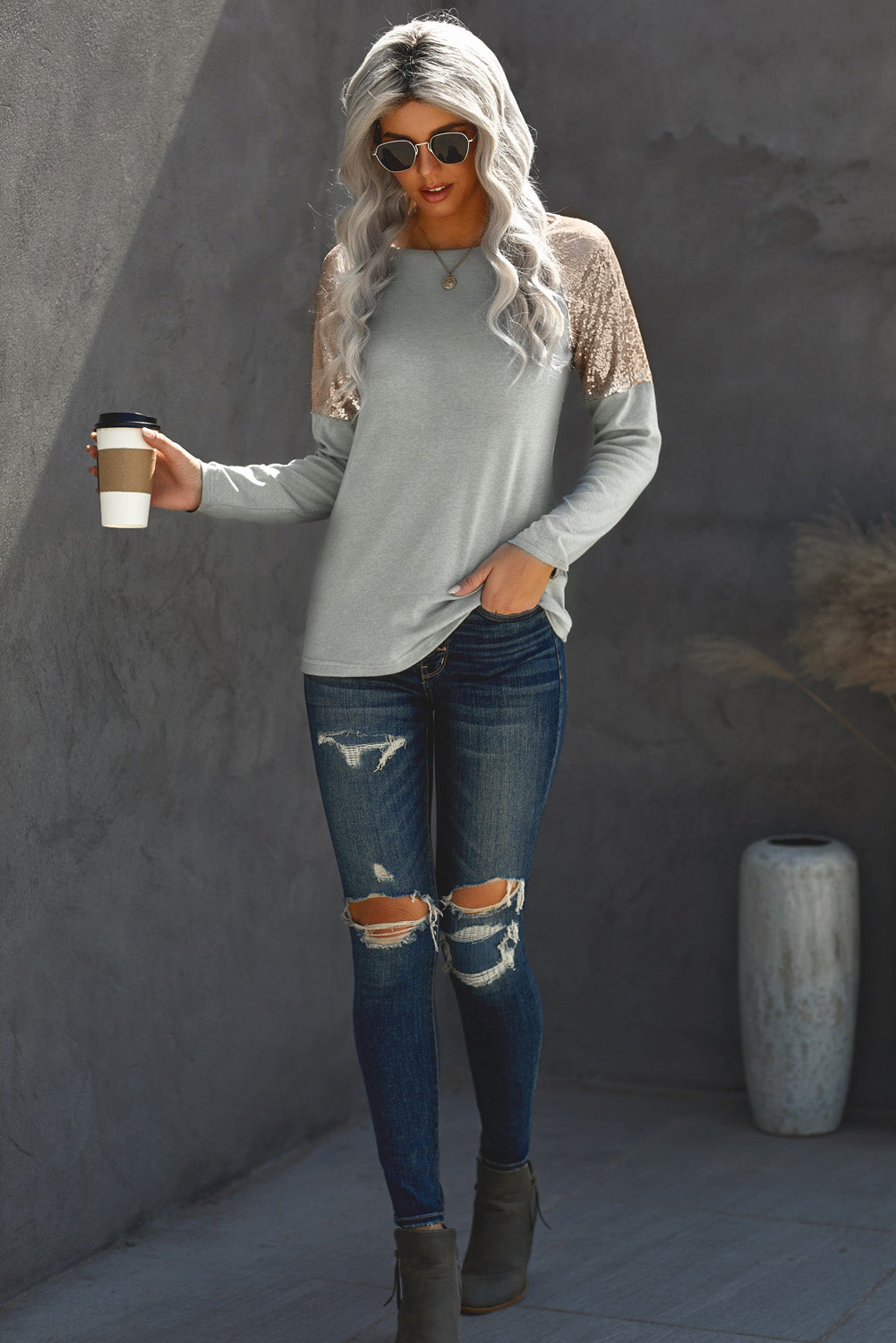 Gray long sleeve top with sequin shoulder detailing, showcasing a classic round neck and soft knit fabric.