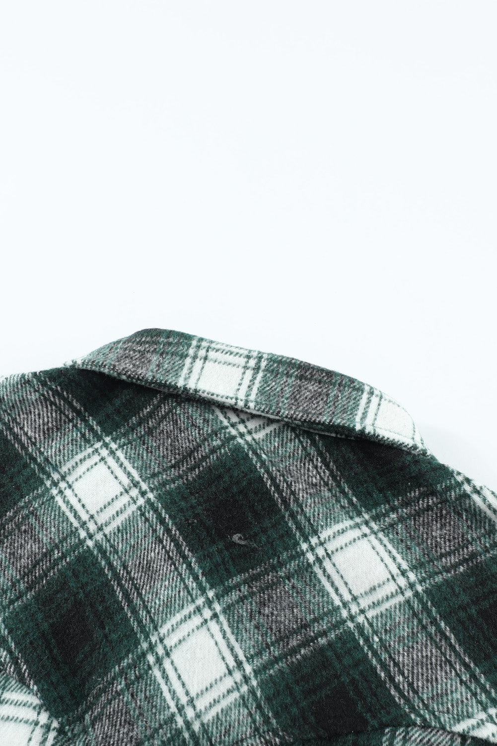 Green plaid shacket with buttons and front pockets, featuring a loose fit and turn-down collar, perfect for casual wear.