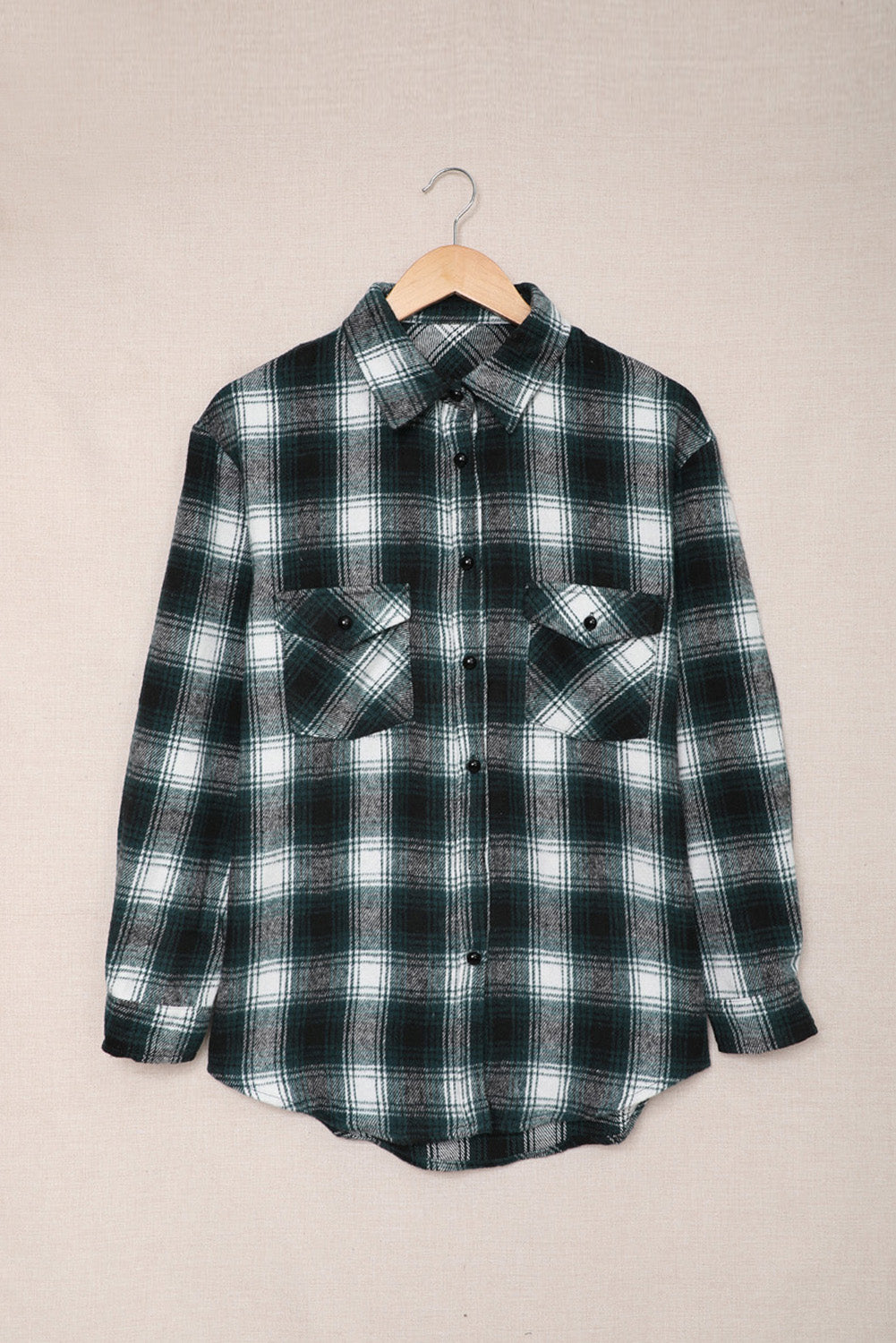 Green plaid shacket with buttons and front pockets, featuring a loose fit and turn-down collar, perfect for casual wear.