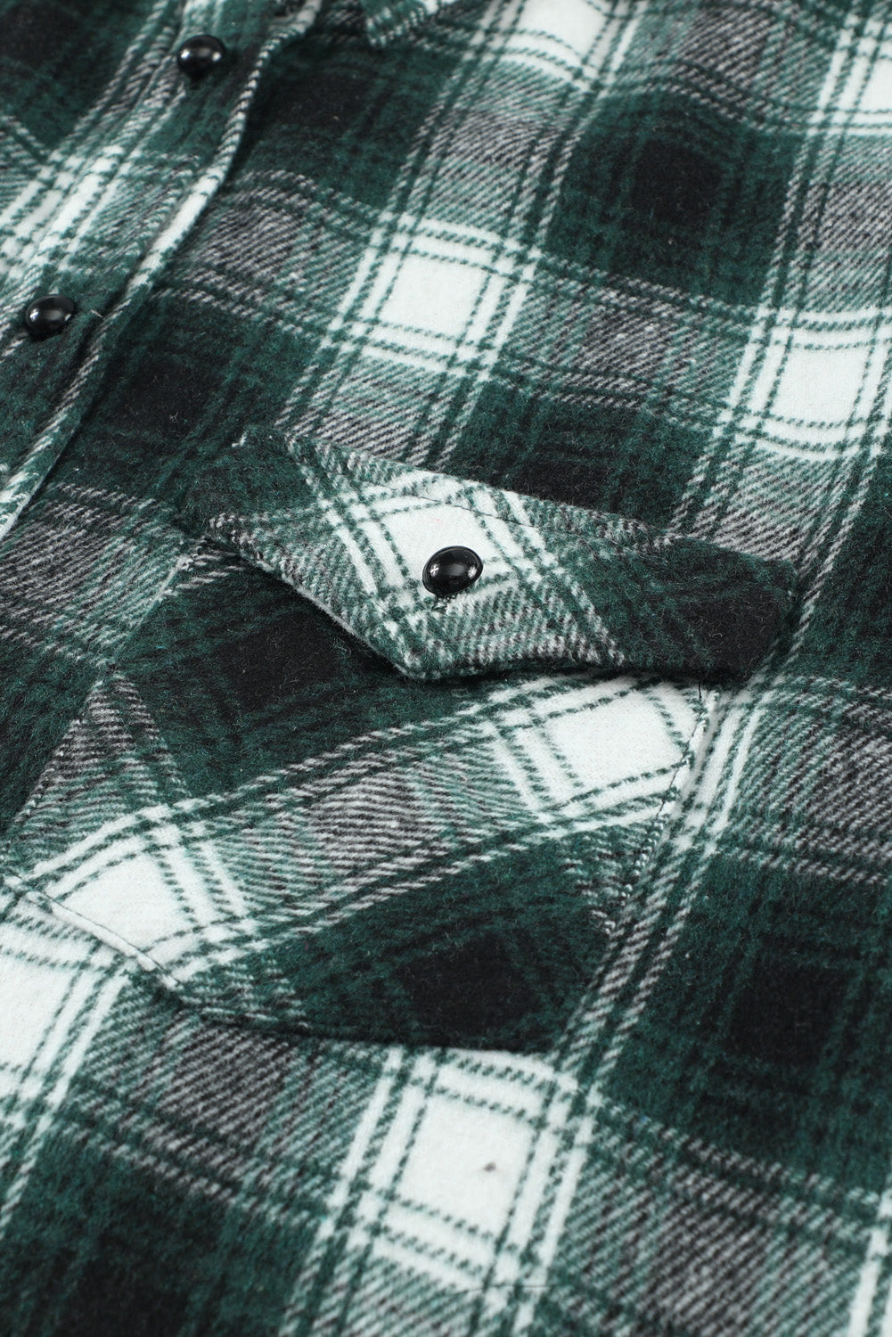 Green plaid shacket with buttons and front pockets, featuring a loose fit and turn-down collar, perfect for casual wear.