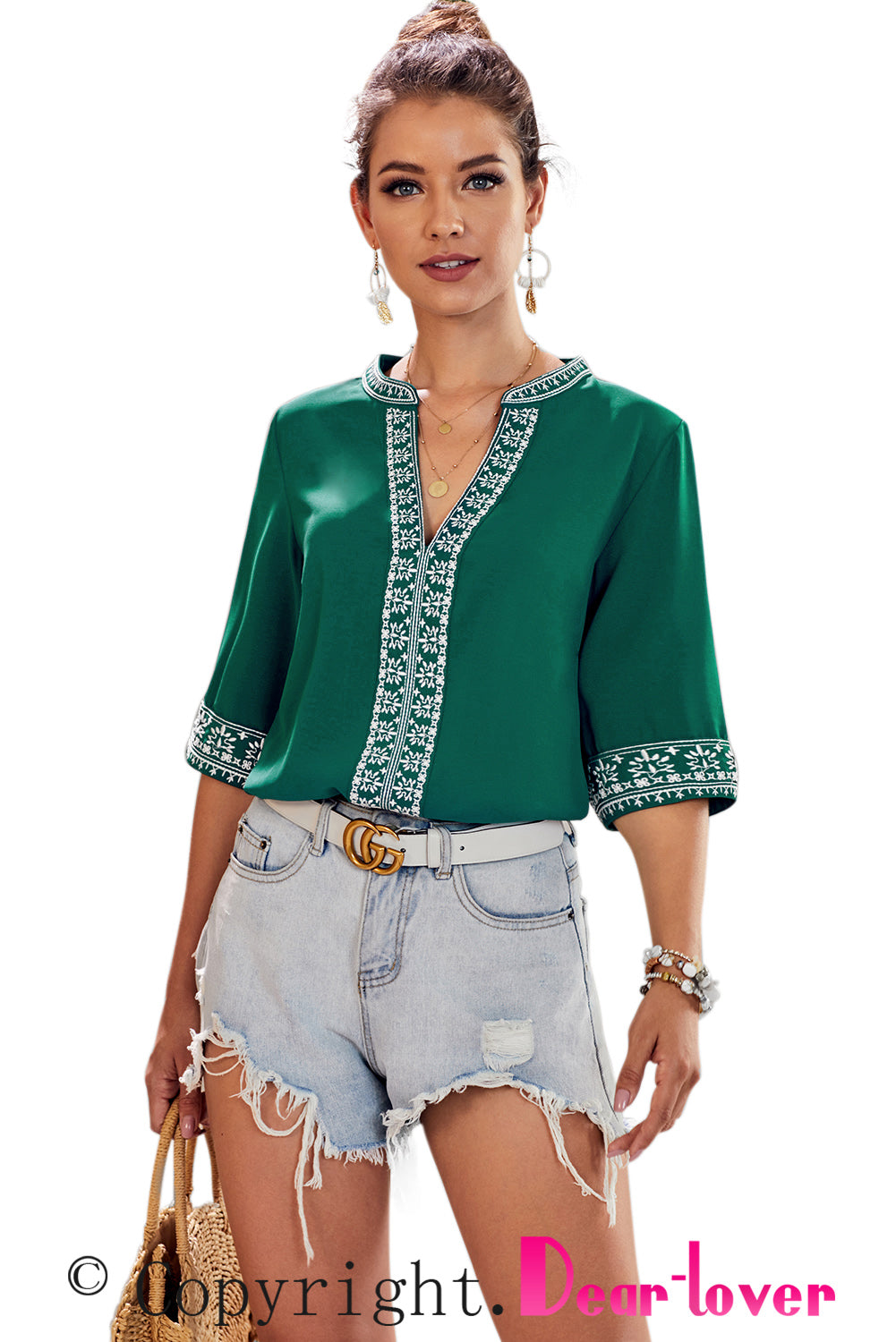 A stylish green boho blouse featuring a v-neckline and half sleeves with floral details, perfect for casual outings.