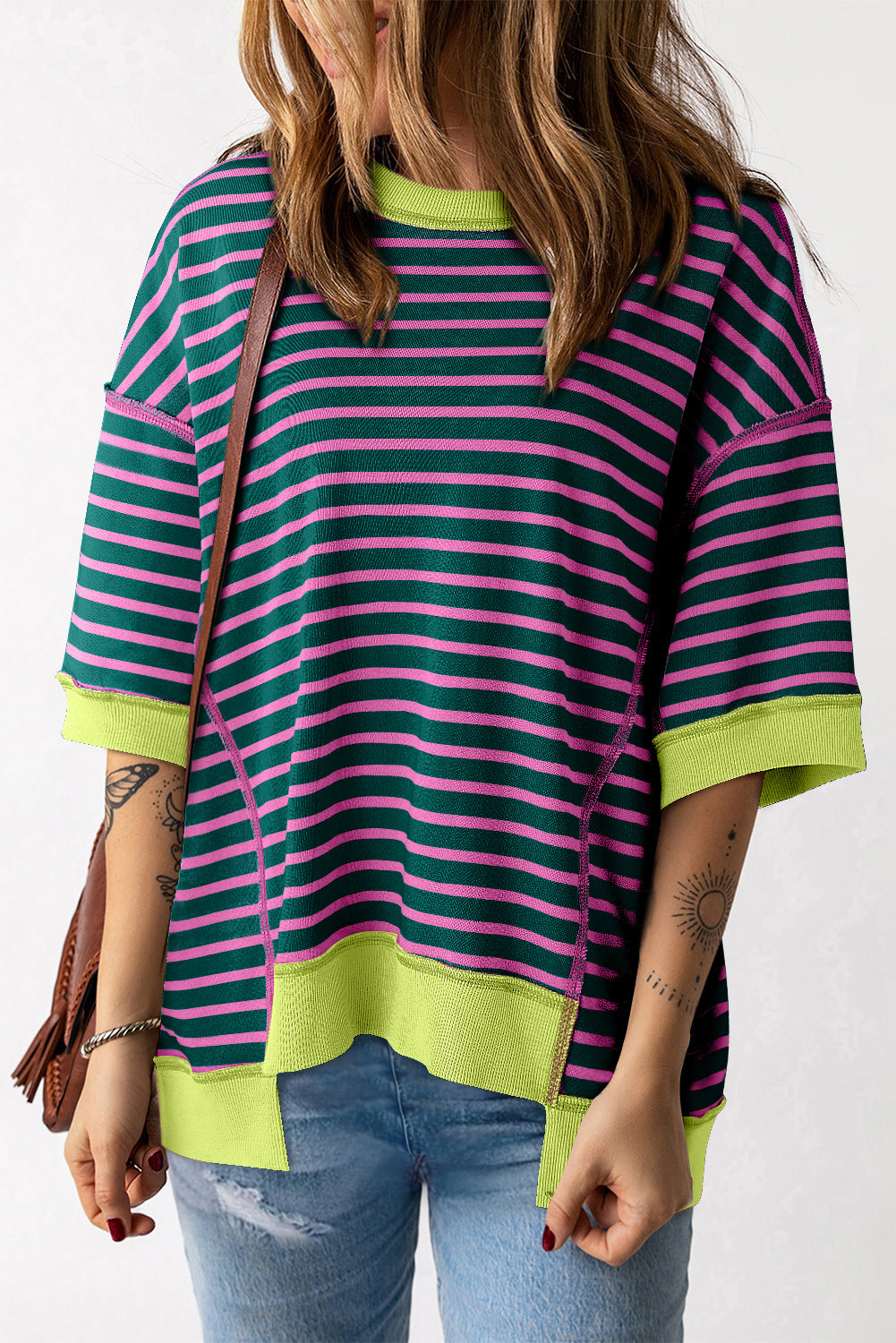 Green Contrast Trim Exposed Seam High Low Stripe T-Shirt displayed on a mannequin, showcasing its stylish design and unique high-low cut.