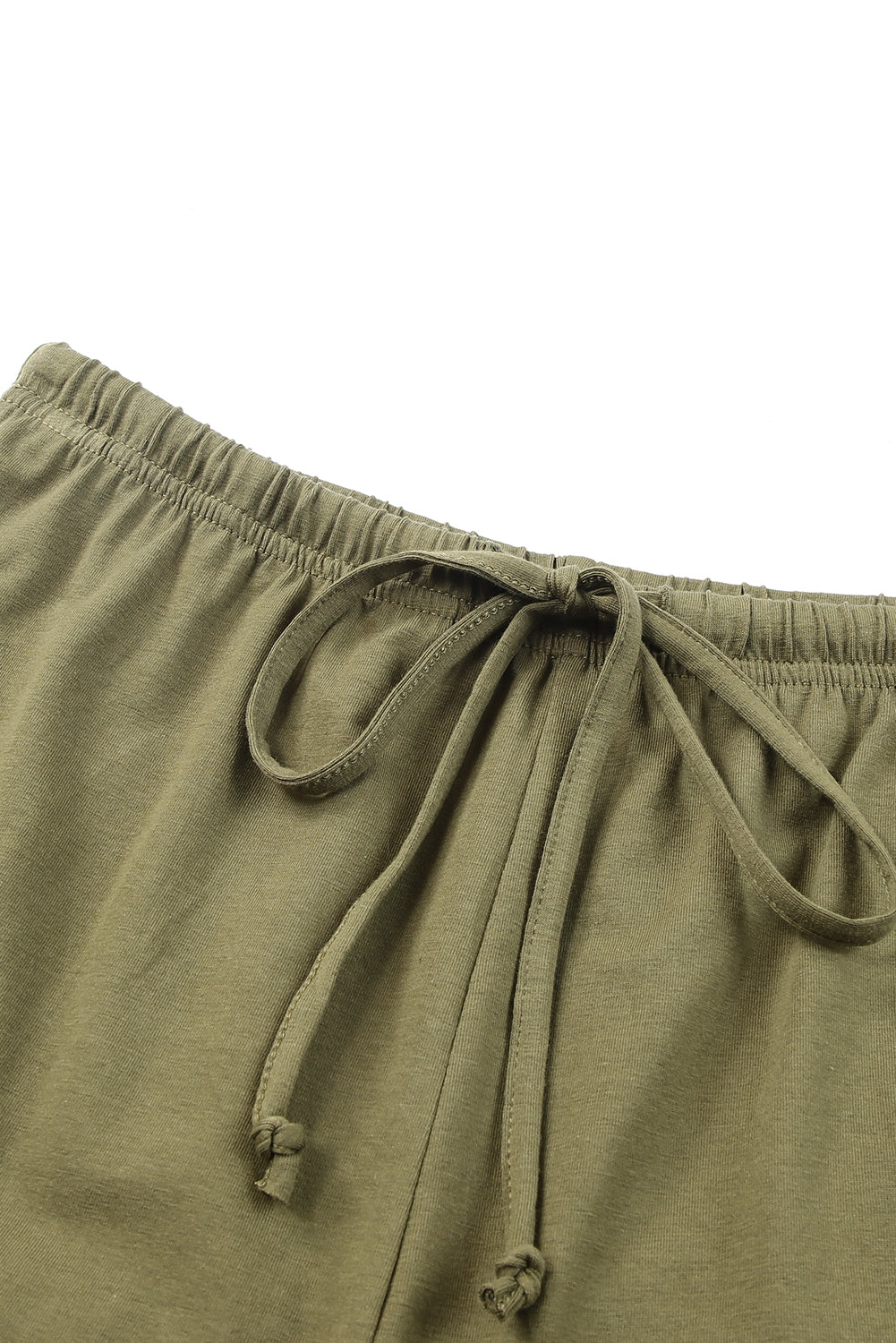 Green crew neck tank top paired with drawstring ruffled shorts, showcasing a stylish and comfortable lounge set for women.