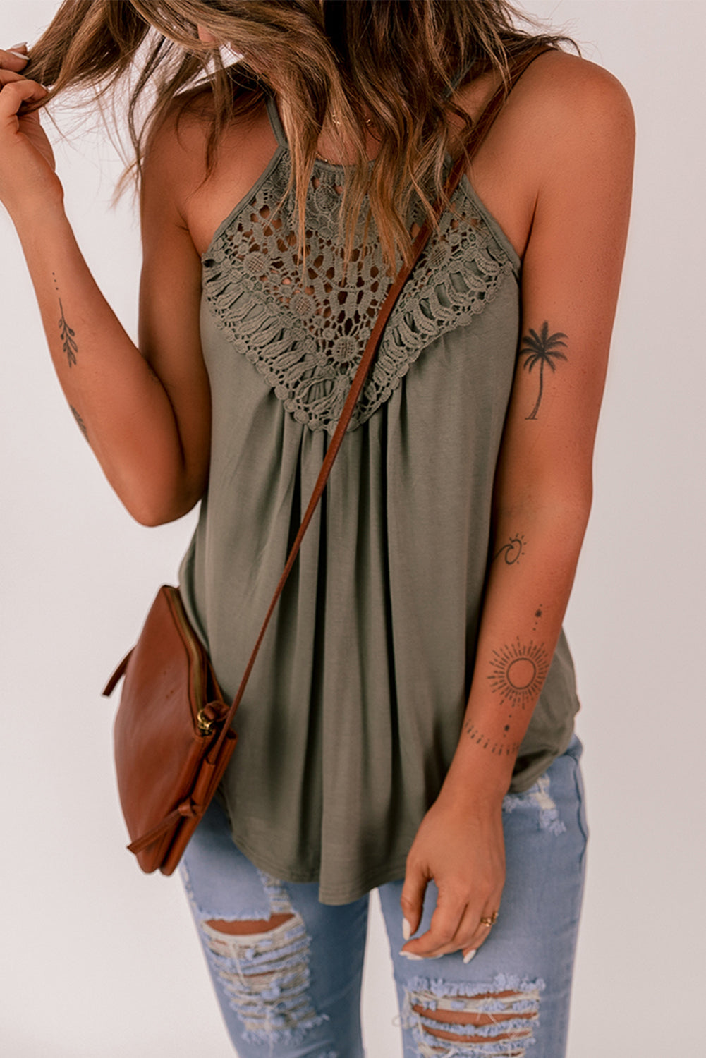 A stylish green tank top featuring intricate crochet lace detailing on the yoke, perfect for summer wear.