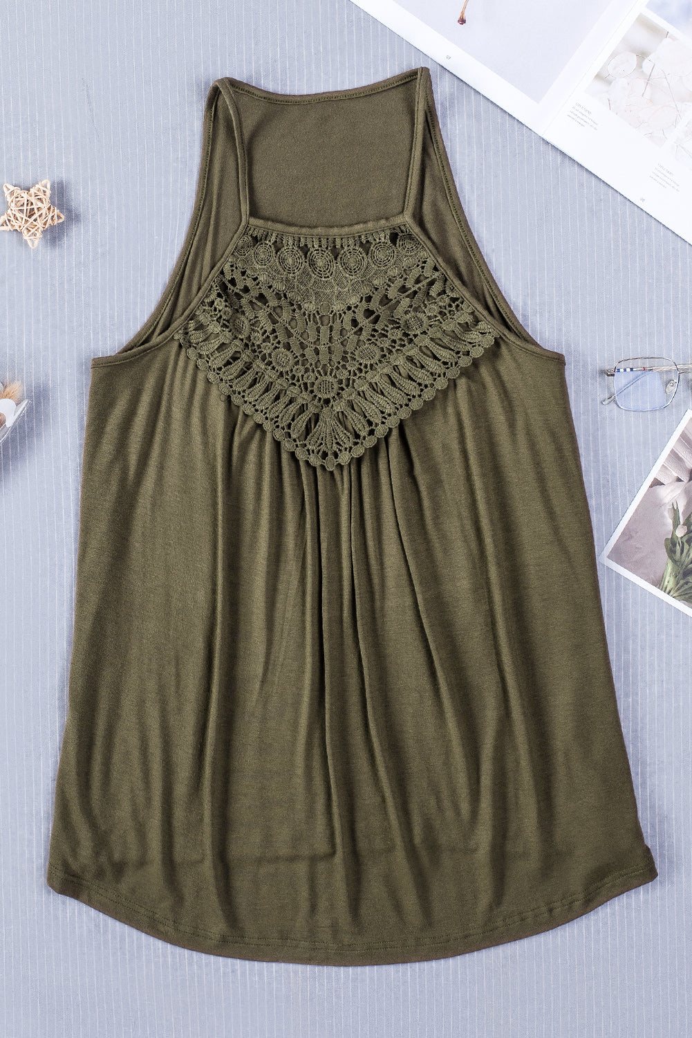 A stylish green tank top featuring intricate crochet lace detailing on the yoke, perfect for summer wear.