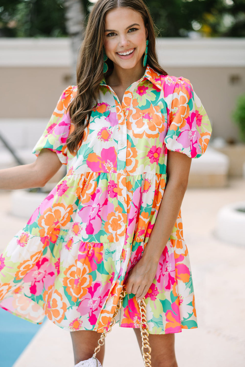 A stylish green floral puff sleeve collar buttoned babydoll dress displayed on a mannequin, showcasing its elegant design and vibrant colors.