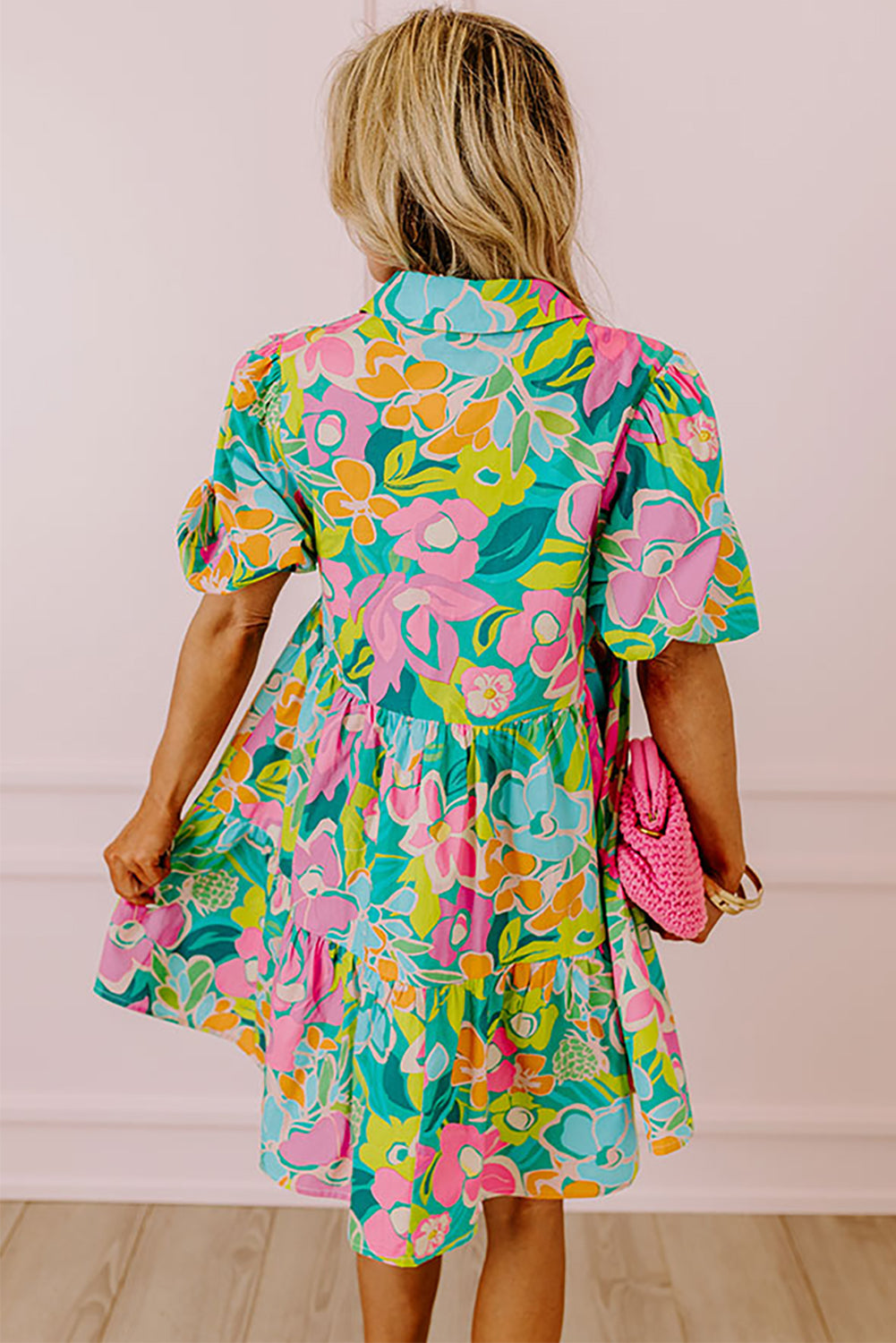 A stylish green floral puff sleeve collar buttoned babydoll dress displayed on a mannequin, showcasing its elegant design and vibrant colors.