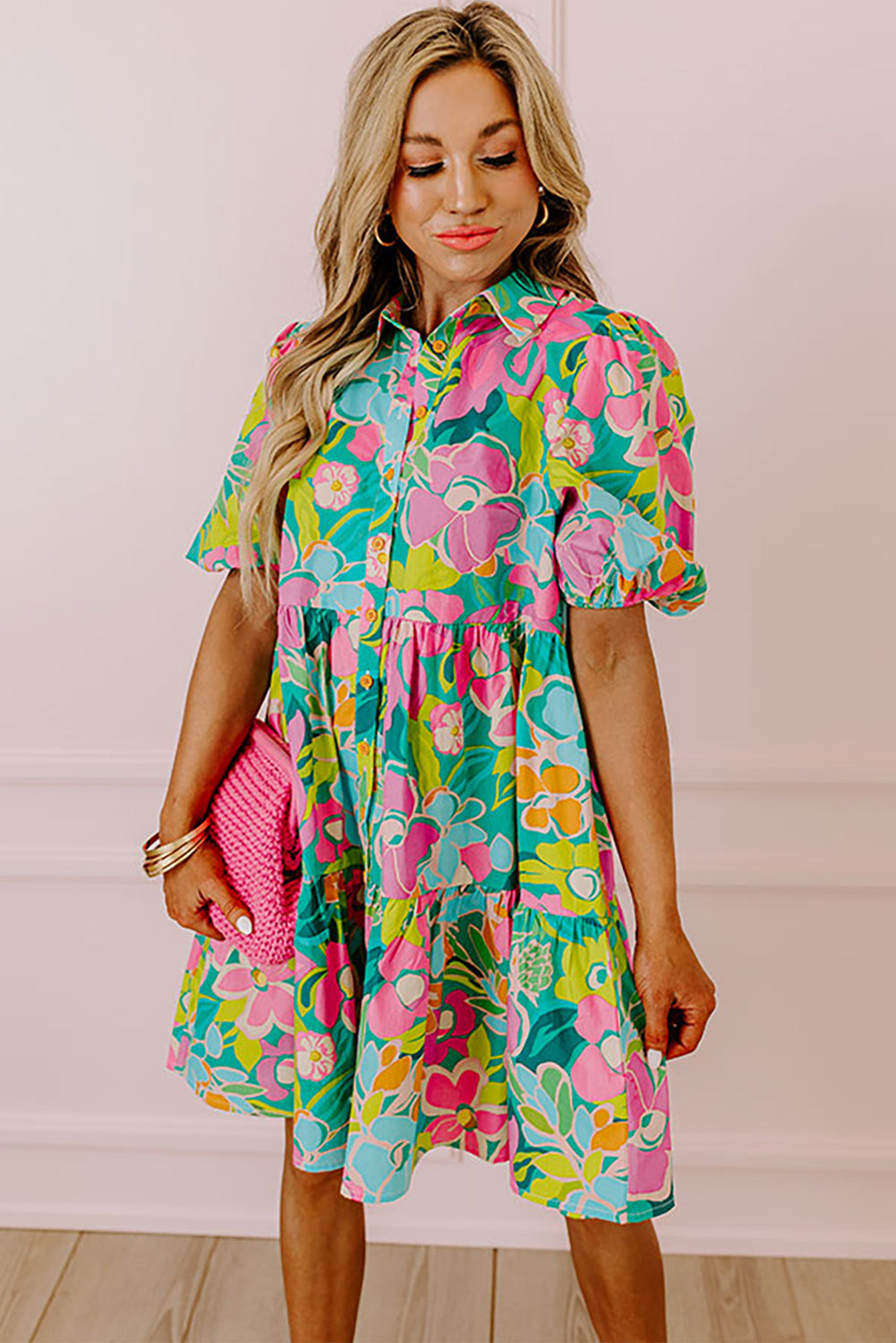 A stylish green floral puff sleeve collar buttoned babydoll dress displayed on a mannequin, showcasing its elegant design and vibrant colors.