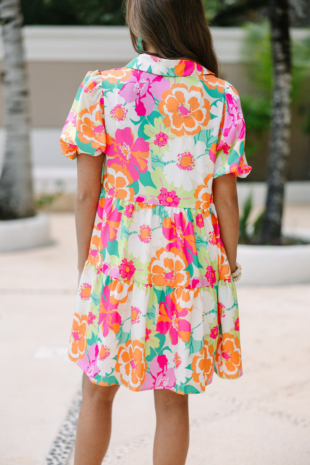 A stylish green floral puff sleeve collar buttoned babydoll dress displayed on a mannequin, showcasing its elegant design and vibrant colors.