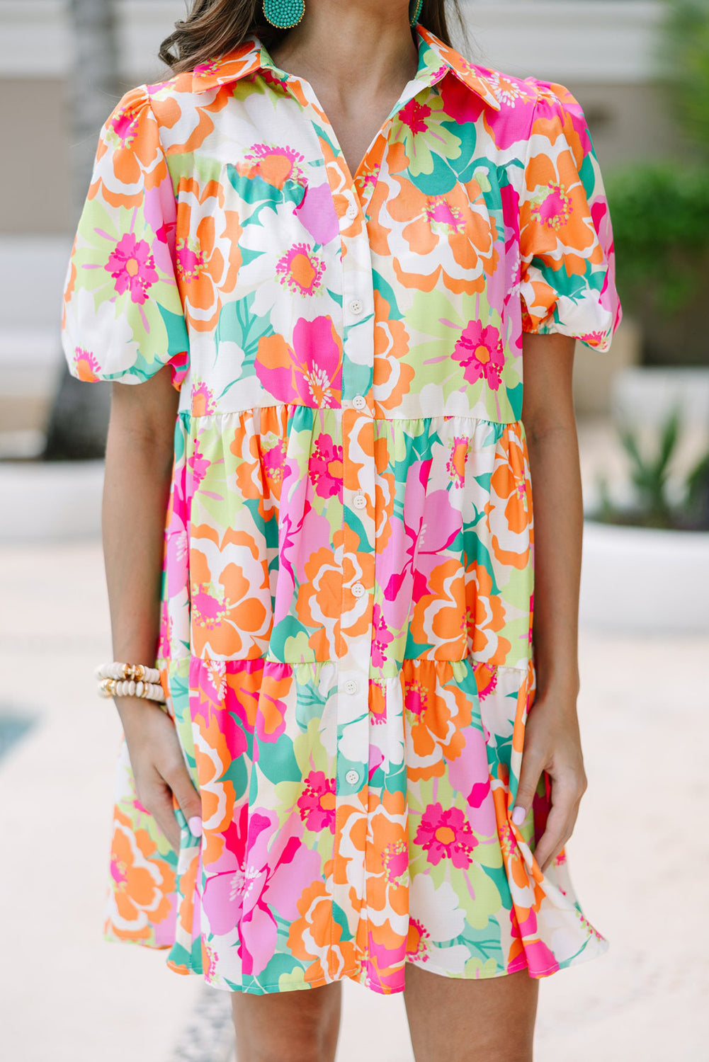 A stylish green floral puff sleeve collar buttoned babydoll dress displayed on a mannequin, showcasing its elegant design and vibrant colors.