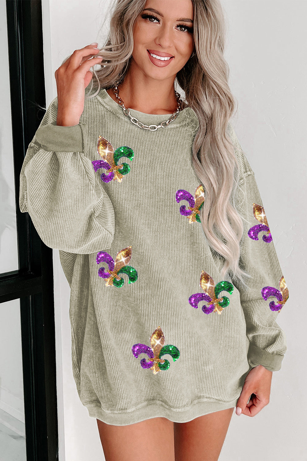 Green Glitter Mardi Gras Symbol Corded Baggy Sweatshirt featuring vibrant glitter design and relaxed fit, perfect for festive celebrations.