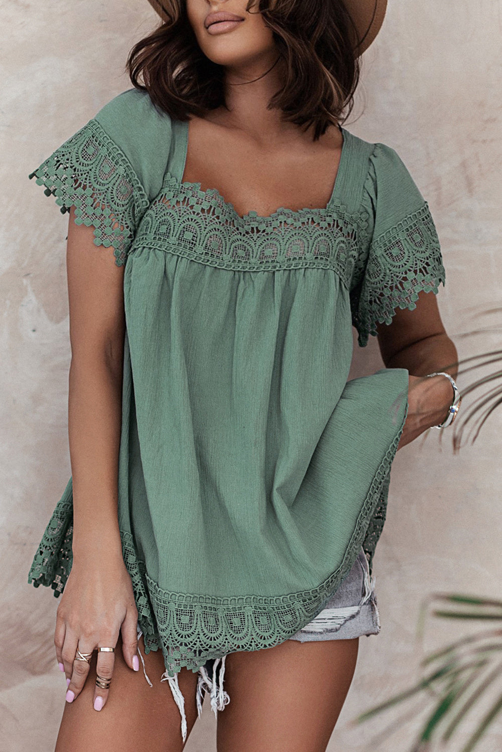 A stylish green blouse featuring lace and pom pom splicing, with a square neck and open back design, perfect for various occasions.