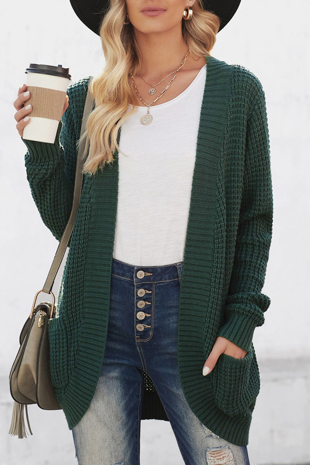 A stylish green pocket knitted solid color cardigan with a fuzzy texture and arc-shaped hem design, perfect for casual wear.