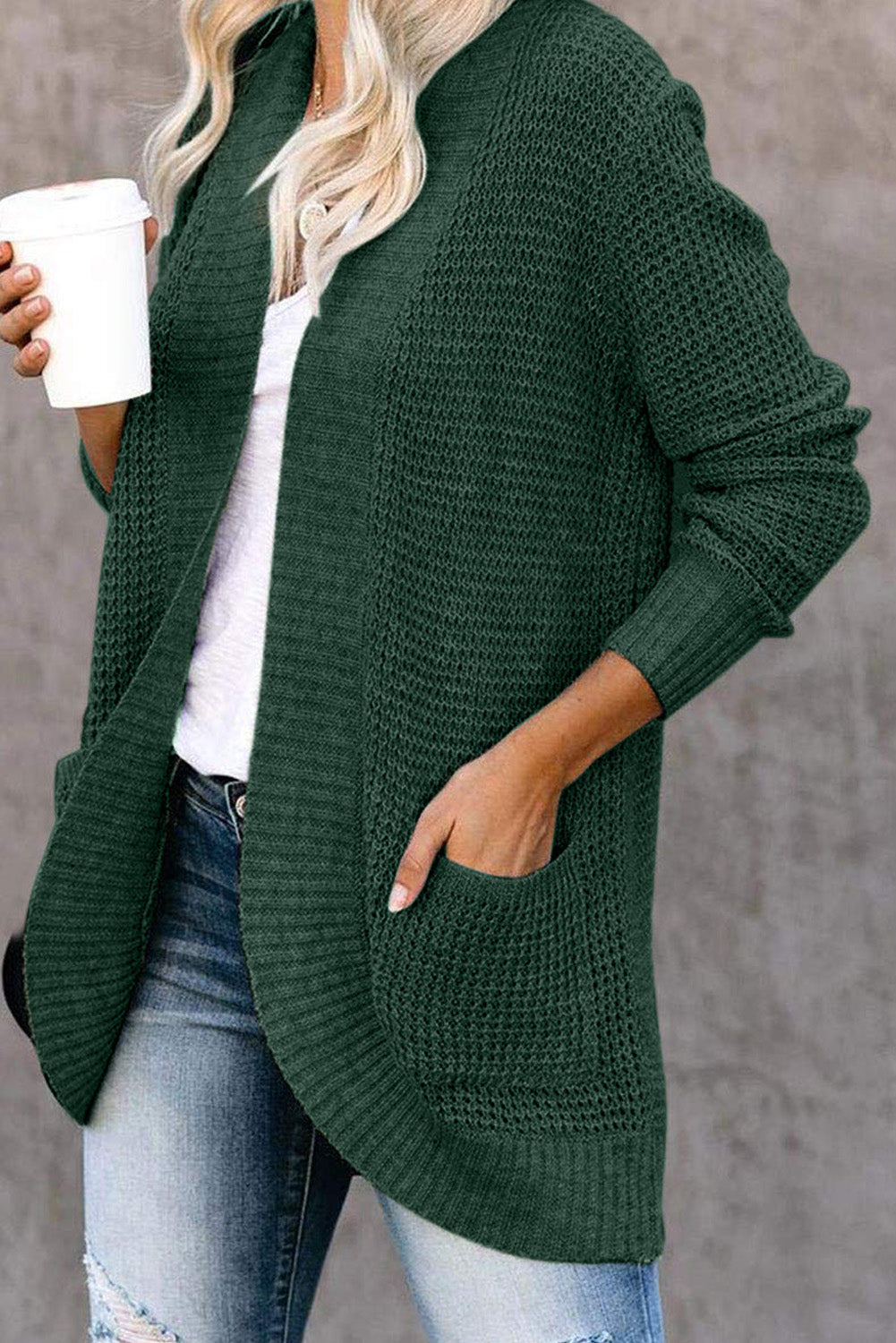 A stylish green pocket knitted solid color cardigan with a fuzzy texture and arc-shaped hem design, perfect for casual wear.