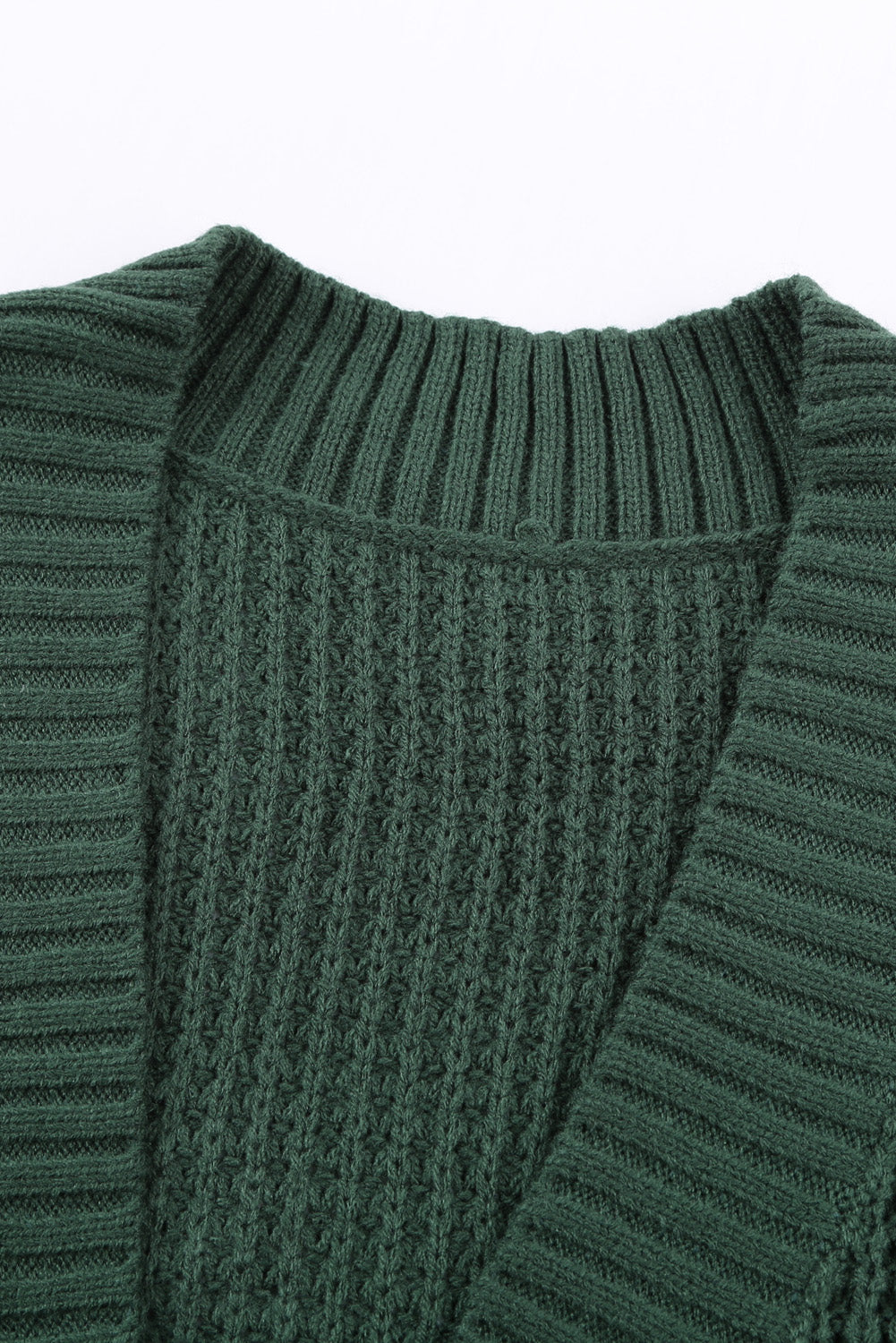 A stylish green pocket knitted solid color cardigan with a fuzzy texture and arc-shaped hem design, perfect for casual wear.