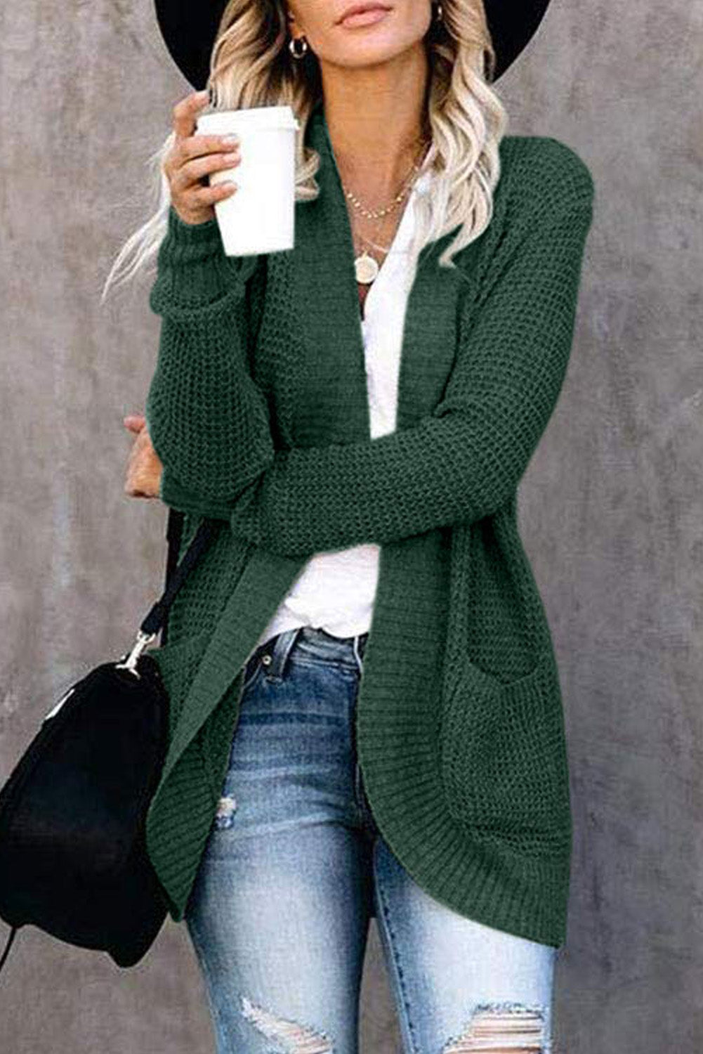 A stylish green pocket knitted solid color cardigan with a fuzzy texture and arc-shaped hem design, perfect for casual wear.