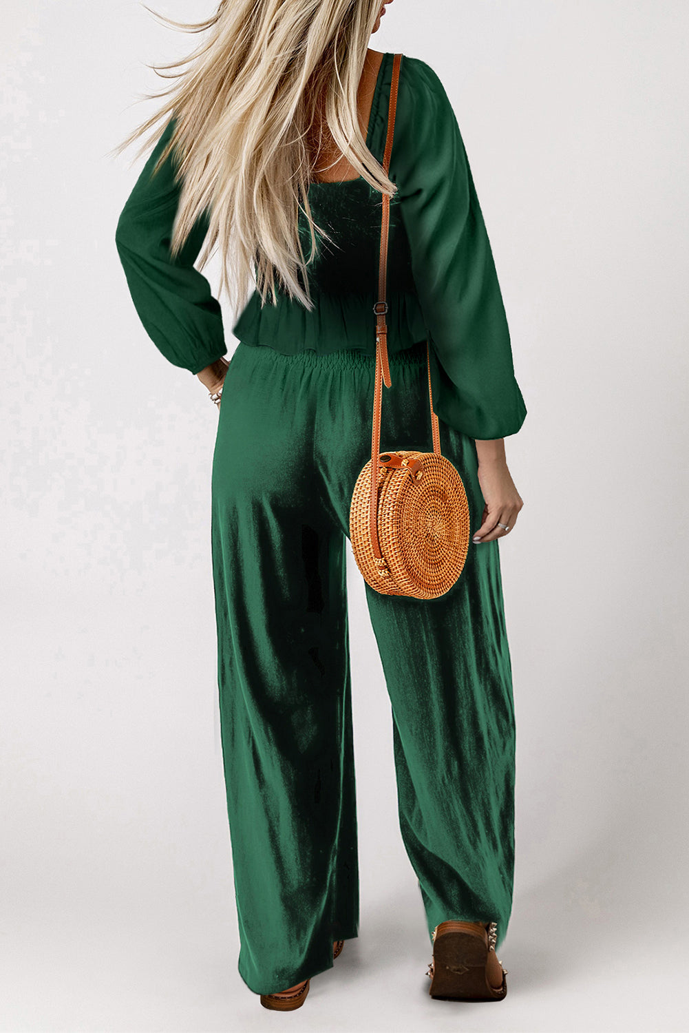 A stylish green square neck smocked peplum top paired with loose high waist pants, showcasing a feminine and elegant look.