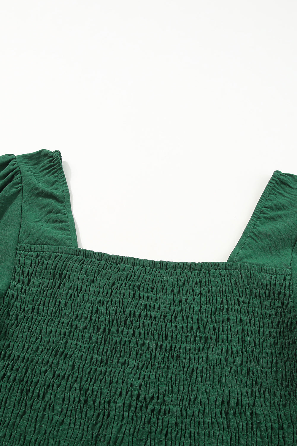 A stylish green square neck smocked peplum top paired with loose high waist pants, showcasing a feminine and elegant look.