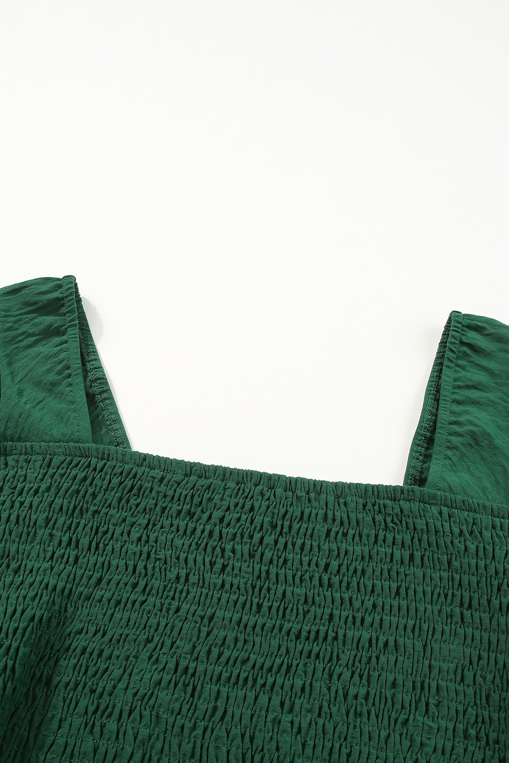 A stylish green square neck smocked peplum top paired with loose high waist pants, showcasing a feminine and elegant look.