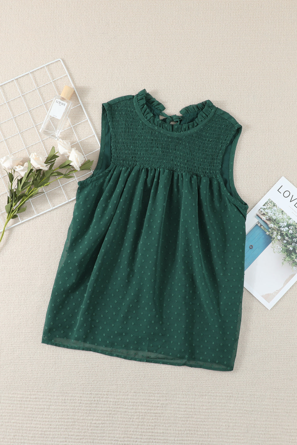 A stylish green tank top featuring Swiss dot and smocked design, with a crew neck and keyhole back, perfect for summer wear.