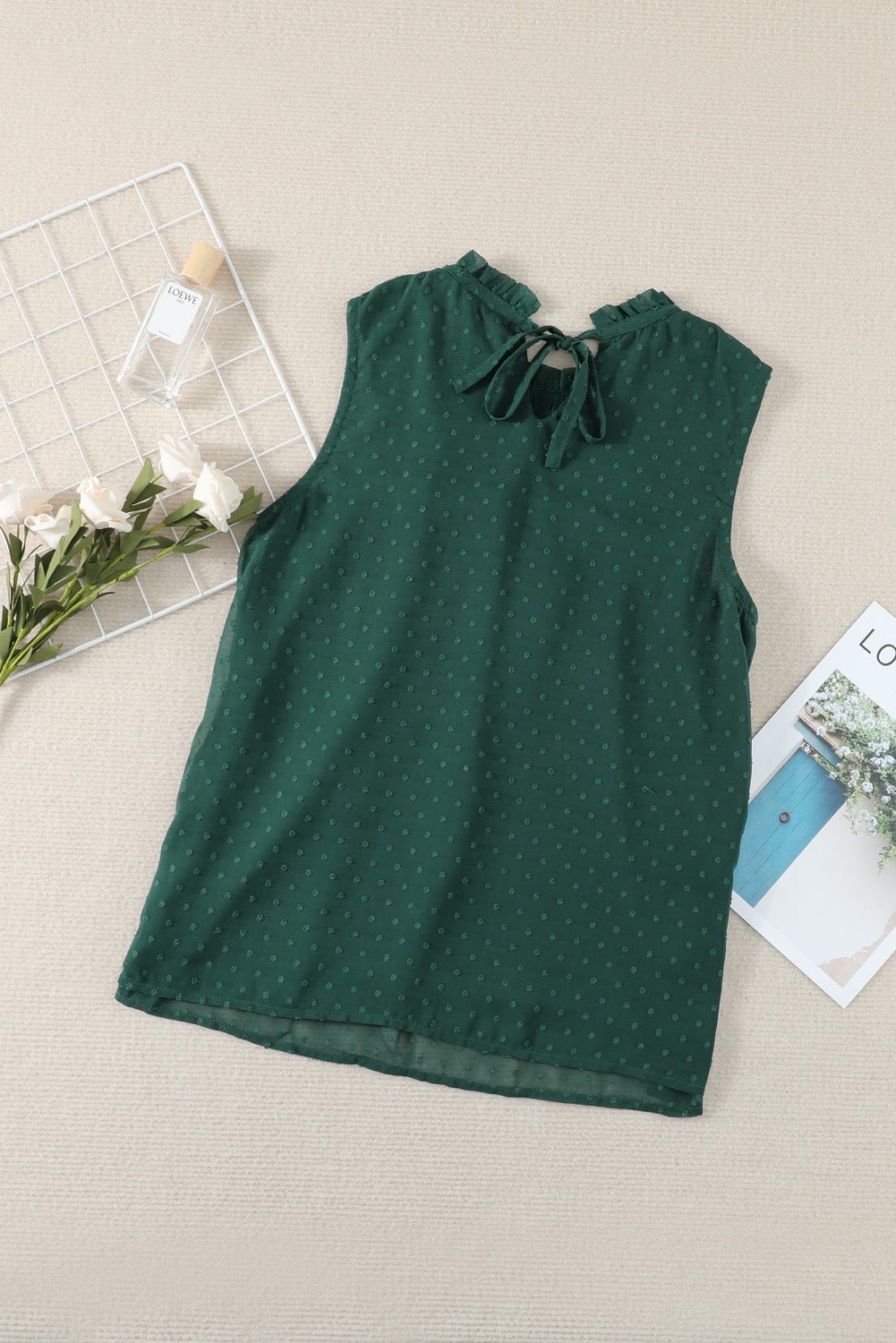 A stylish green tank top featuring Swiss dot and smocked design, with a crew neck and keyhole back, perfect for summer wear.