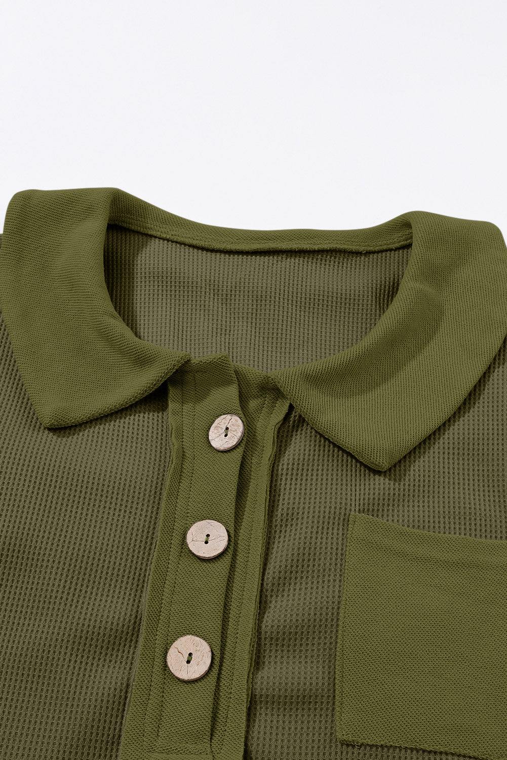 A stylish green waffle knit long sleeve top with buttons, perfect for casual wear and layering.